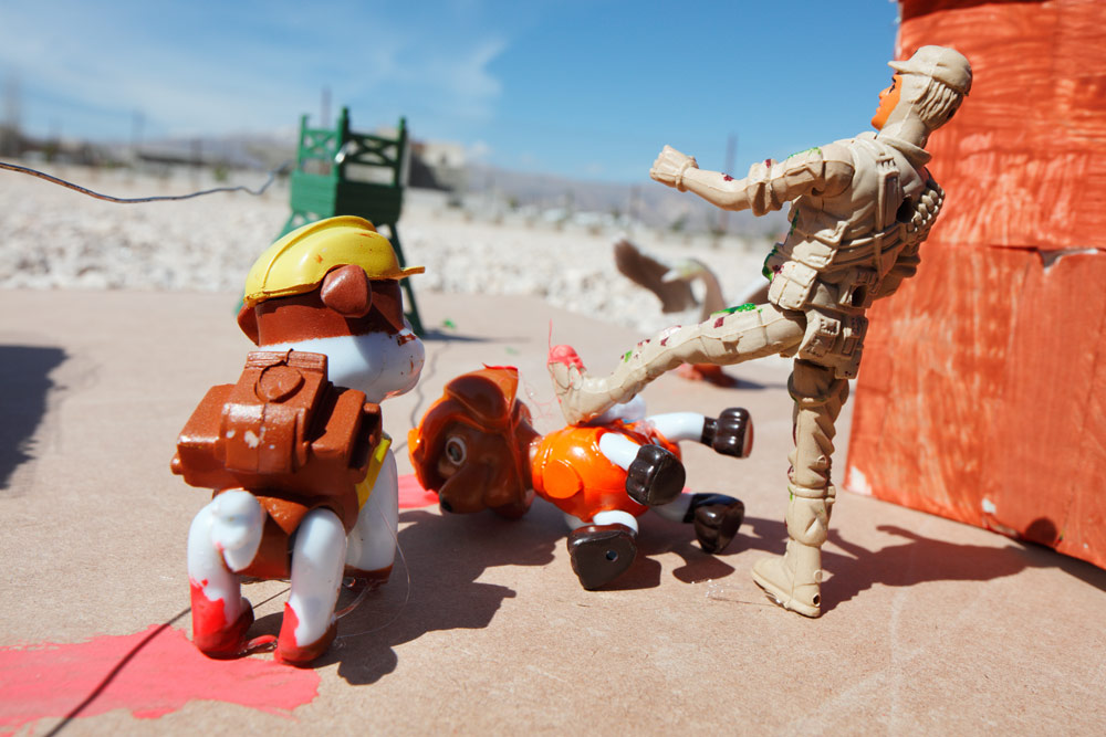Closeup of the soldier and dogs on the destroyed street. 
