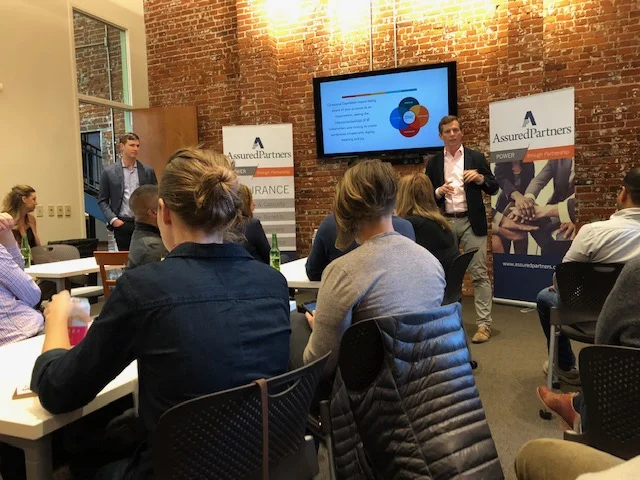 John Lowe, CEO of Jeni’s Splendid Ice Creams (standing on right) and Josh Harrison, President of Improving - Columbus (standing far left) led tonight’s Conscious Capitalism presentation.