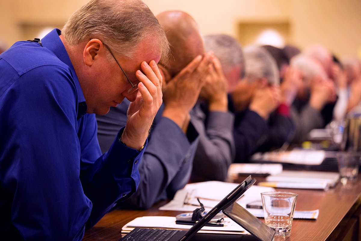 Rick Remmers, president of the Seventh-day Adventist Church in the Chesapeake Region, joins other leaders from throughout North America in prayer. (NAD Communication/Dan Weber)