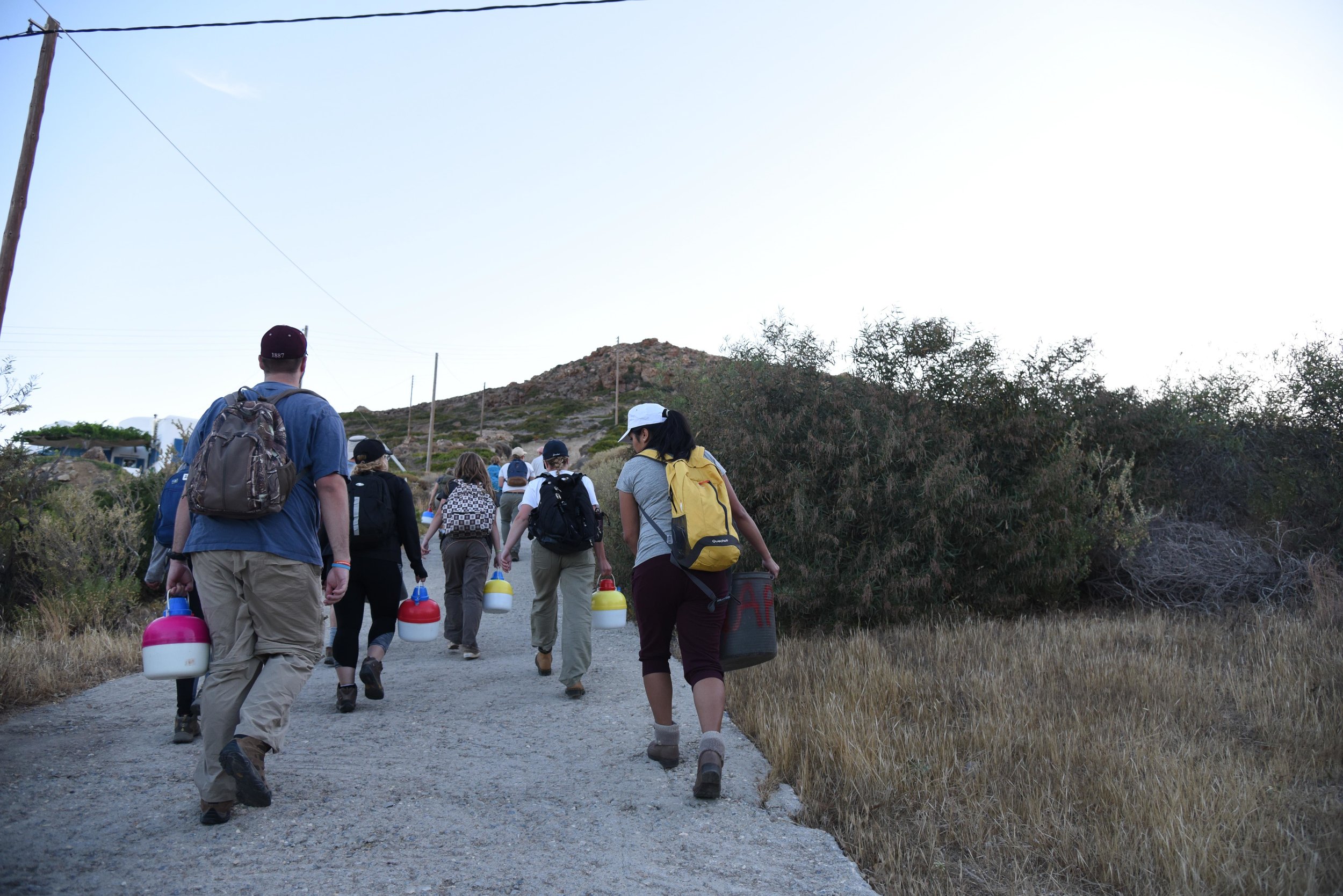 Part of the crew carrying tools and water up the hill for the day in the early hours of the morning.
