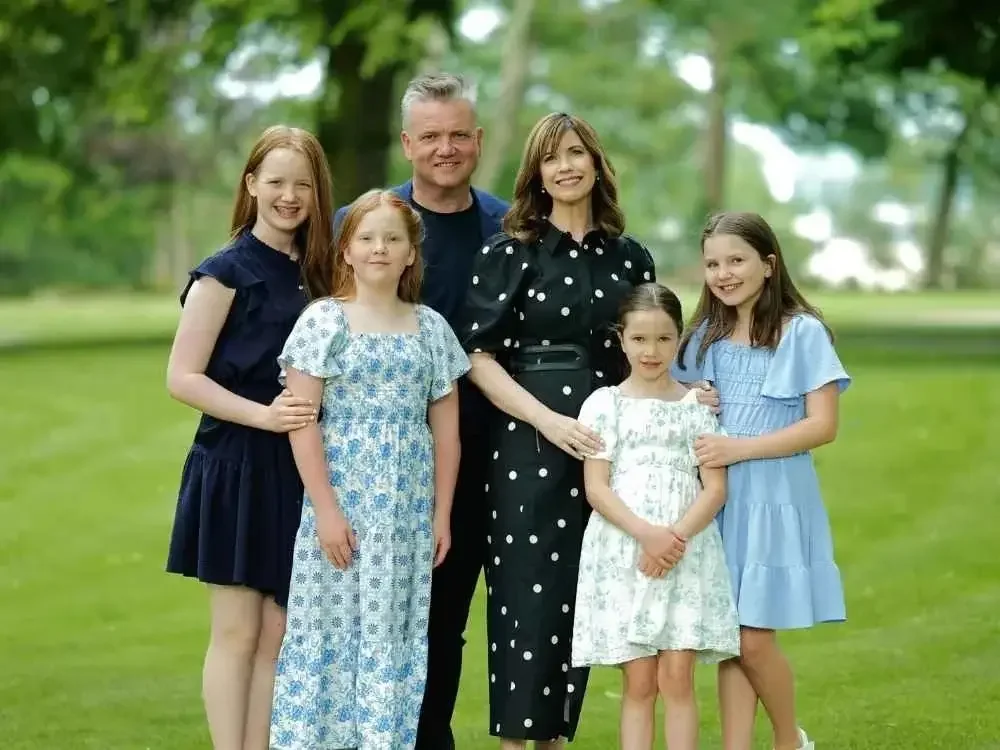 A family gathered together for Family Hymn of the Month