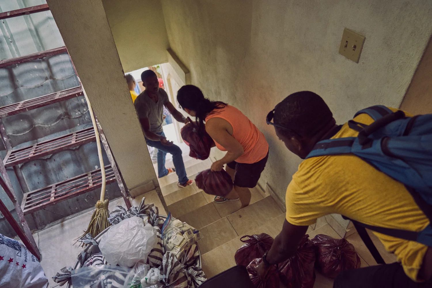Among The Reeds founder, Jamie Hatleberg (pictured center) passes along care packages for the journey to Les Cayes.