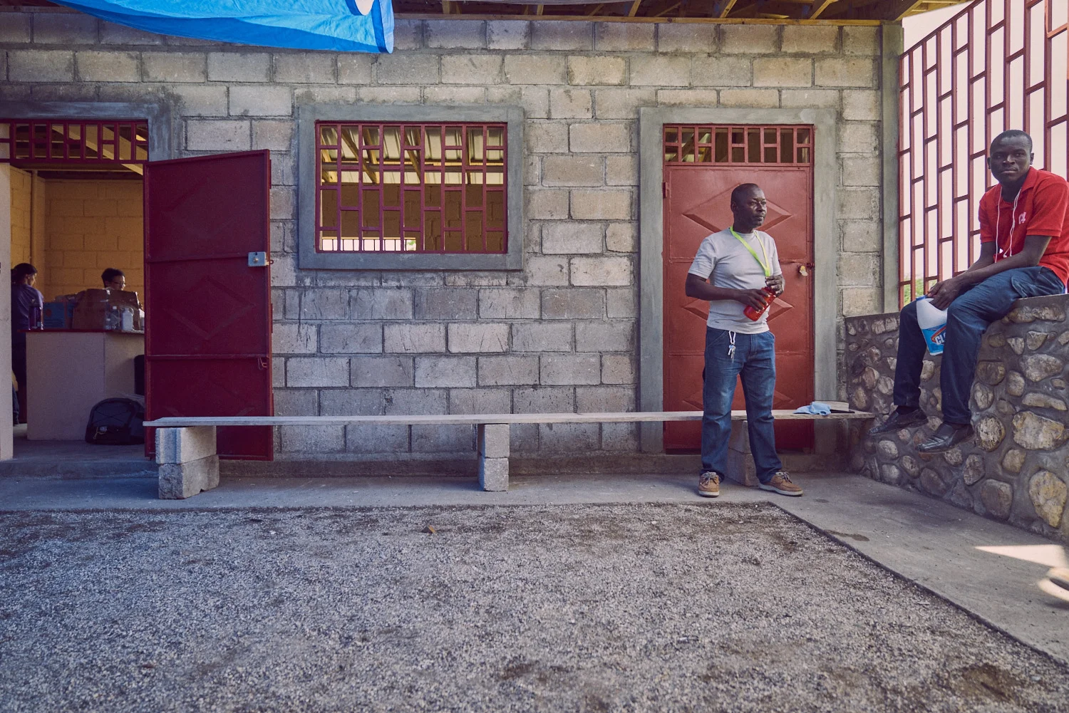 The administrative building's main courtyard. A view of the Among The Reeds mobile pharmacy can be seen through the door (left).