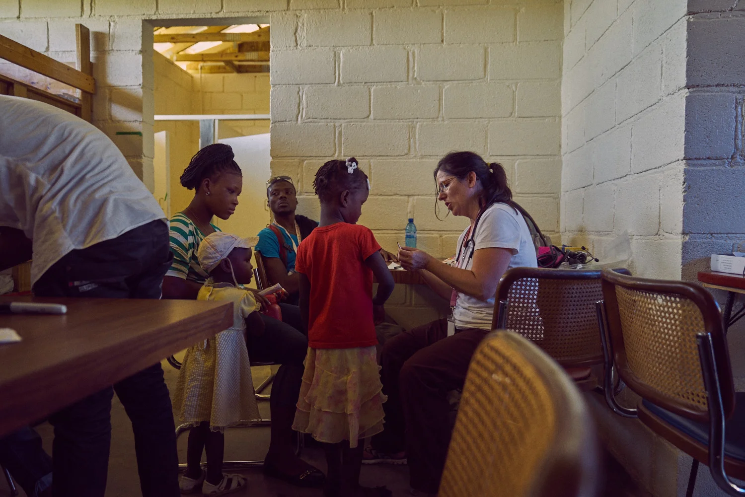 General concerns are addressed in the room adjacent to the pharmacy. Among The Reeds founder, Jamie Hatleberg (right) interacts with a patient.