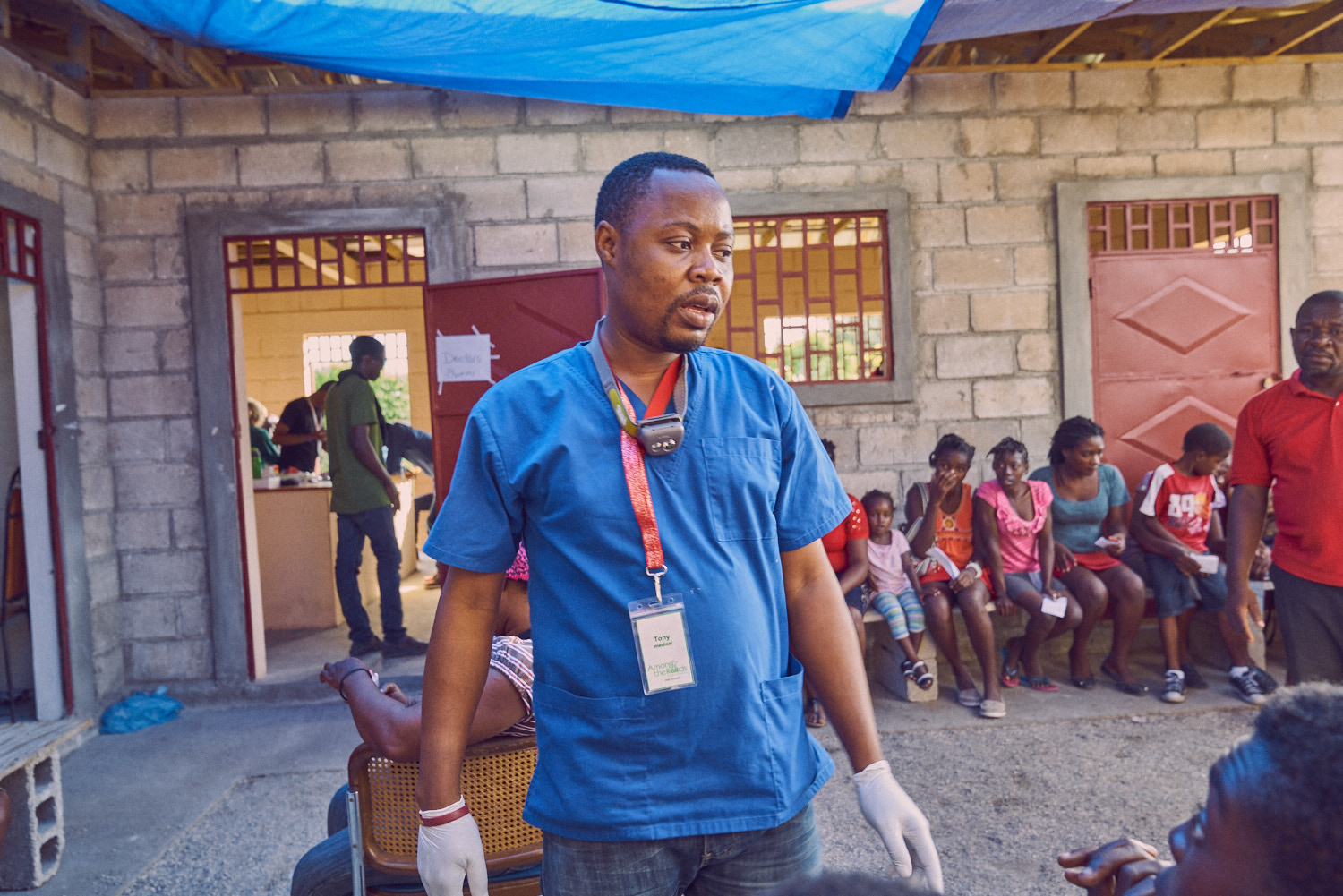 Local dentist Cajouste Tony Jean-pierre (center) interacting with a patient.