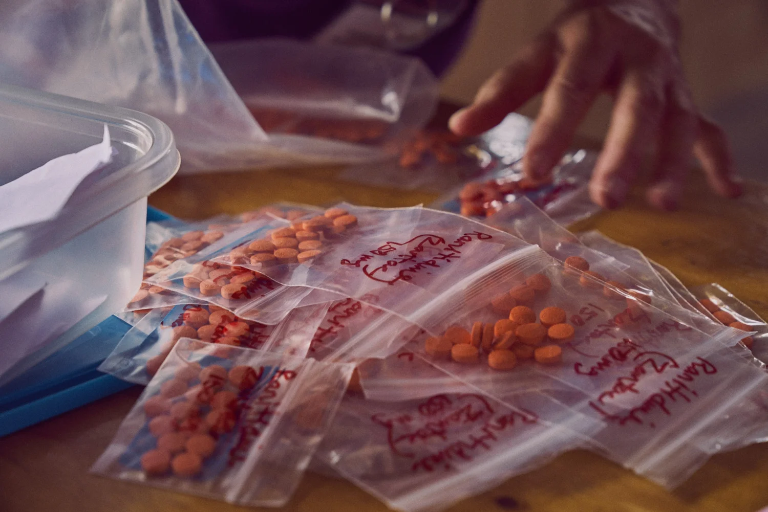 ATR team member Vahn sorting medications in the pharmacy.