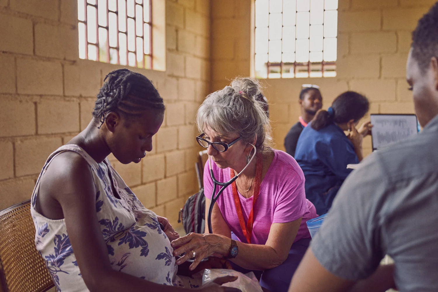 Among The Reeds team member Linda Jacobsen (center) providing prenatal care to a severely dehydrated young woman.