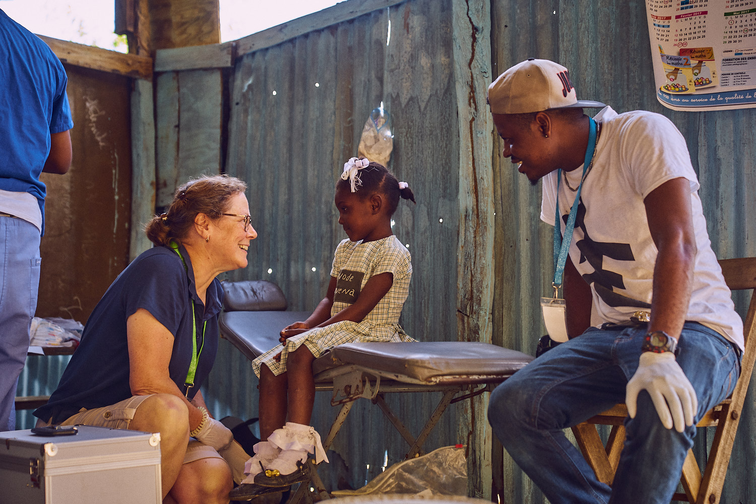 MaryJane Lungren (left) and Pa Touche Evans Josma (right) greet a student.