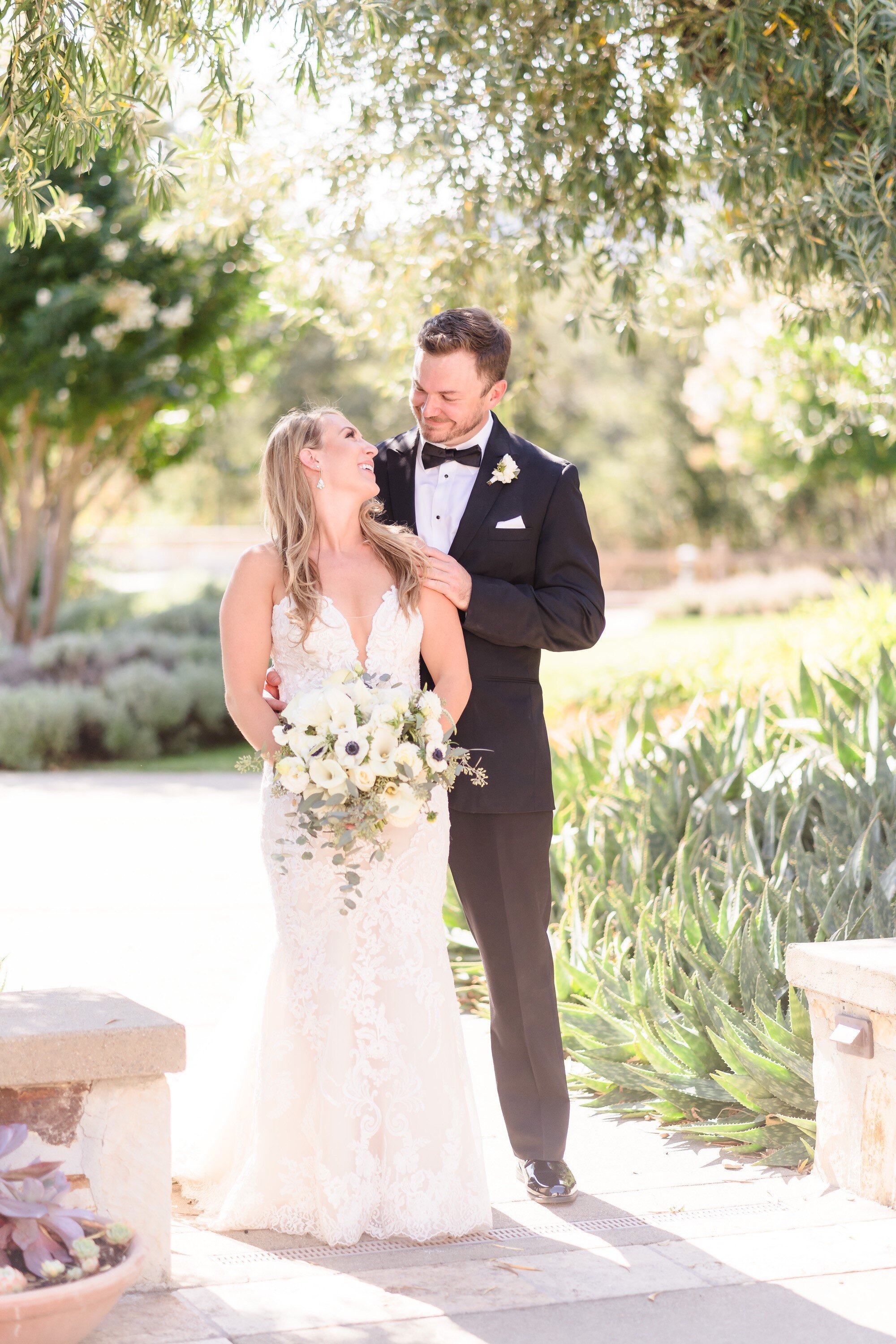 bride and groom posing under the trees at holman ranch in carmel ca