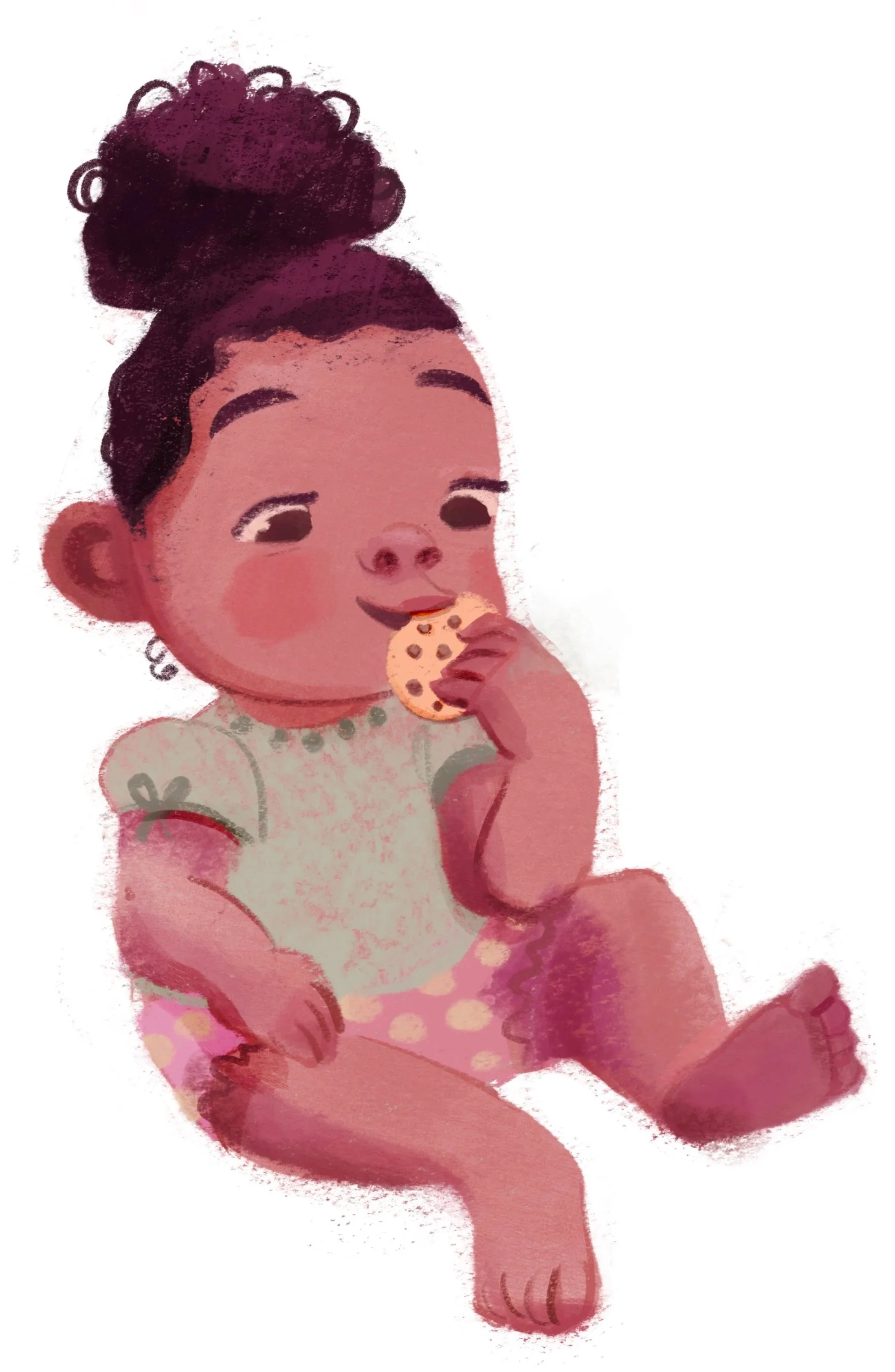 A young girl with dark curly hair tied in a bun, sitting and eating a chocolate chip cookie. She is wearing a light-colored dress with short sleeves and pink polka dot shorts.