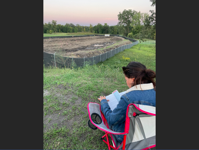 Amber, ironically doing her oil and gas law homework in front of the Enbridge dig site.