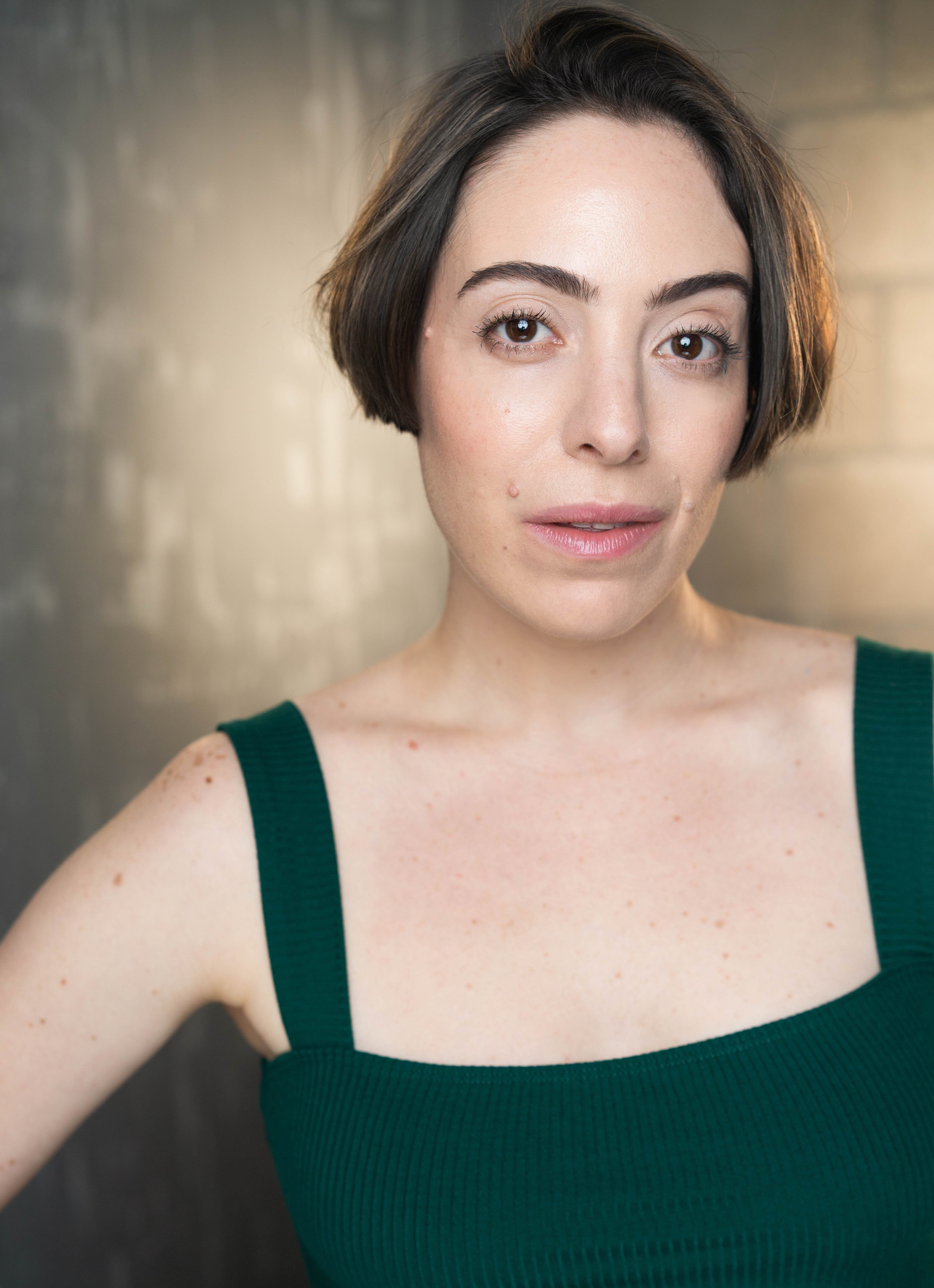  Headshot of actor Yvonne Cone in a dark green thick-strapped tank top. 
