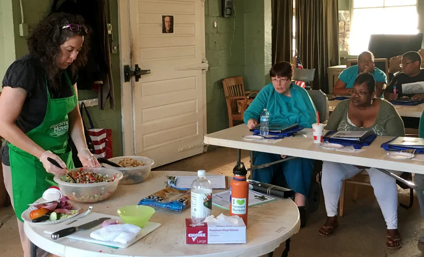 Nutrition educator Jeanell Smith demonstrates for FreshRx participants how to make a delicious fresh salsa.