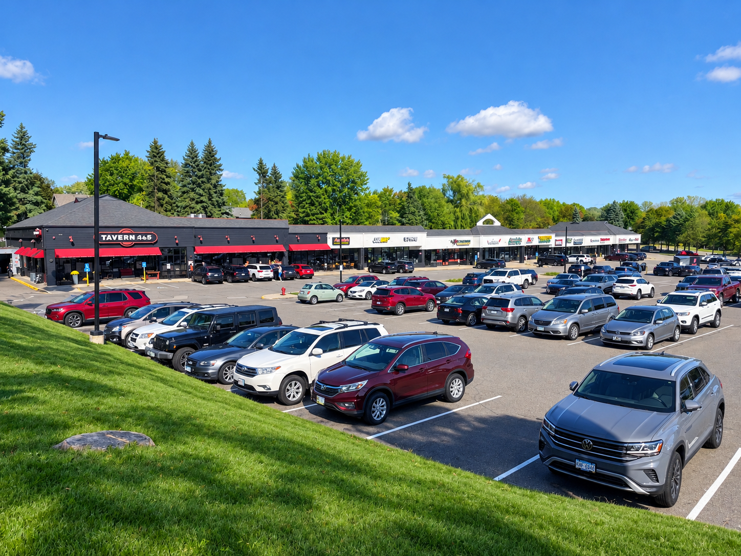 Sunny Suburban Shopping Plaza and Parking Lot.png