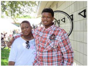 Latasha Glen with son Malcolm, near KFM bike racks