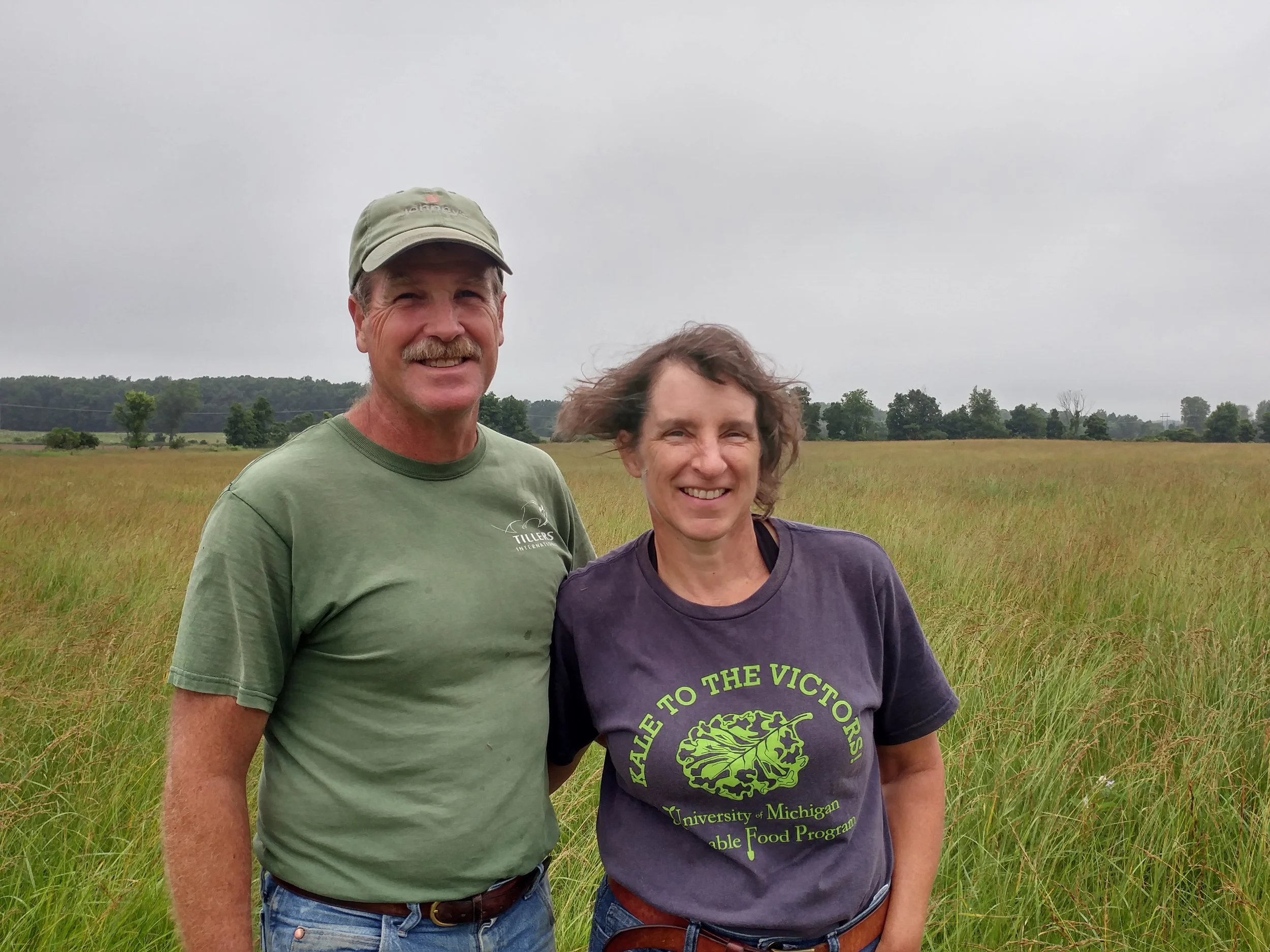 Pete and Lori in a portion of their grazing pasture. They are conscious of growing a variety of natural grazing grasses to mimic what would be available to sheep in the wild.