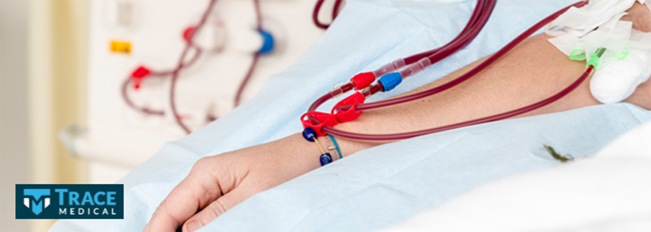 Person in a hospital bed receiving dialysis treatment