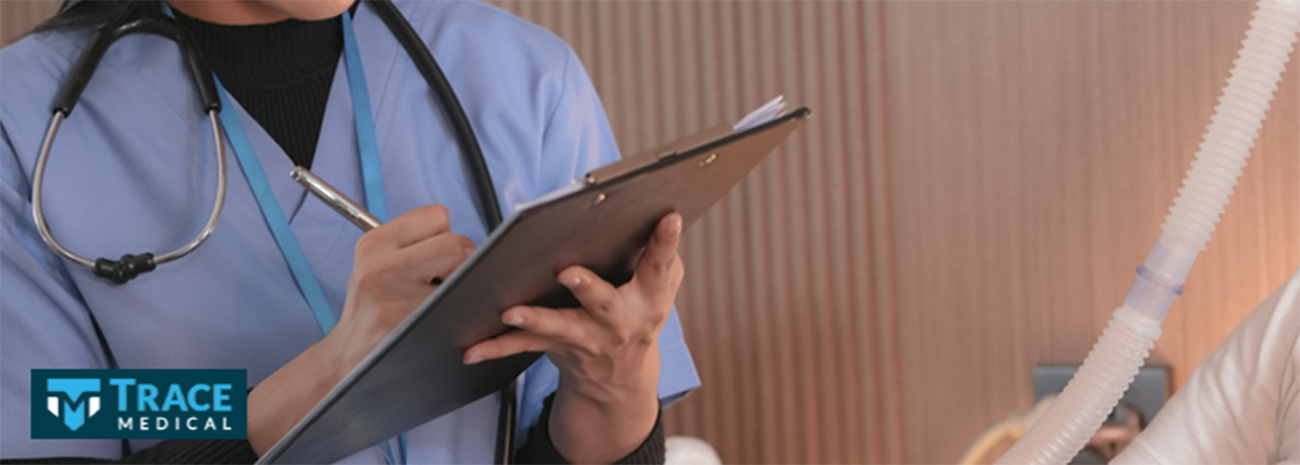 Woman in scrubs taking notes on a clipboard
