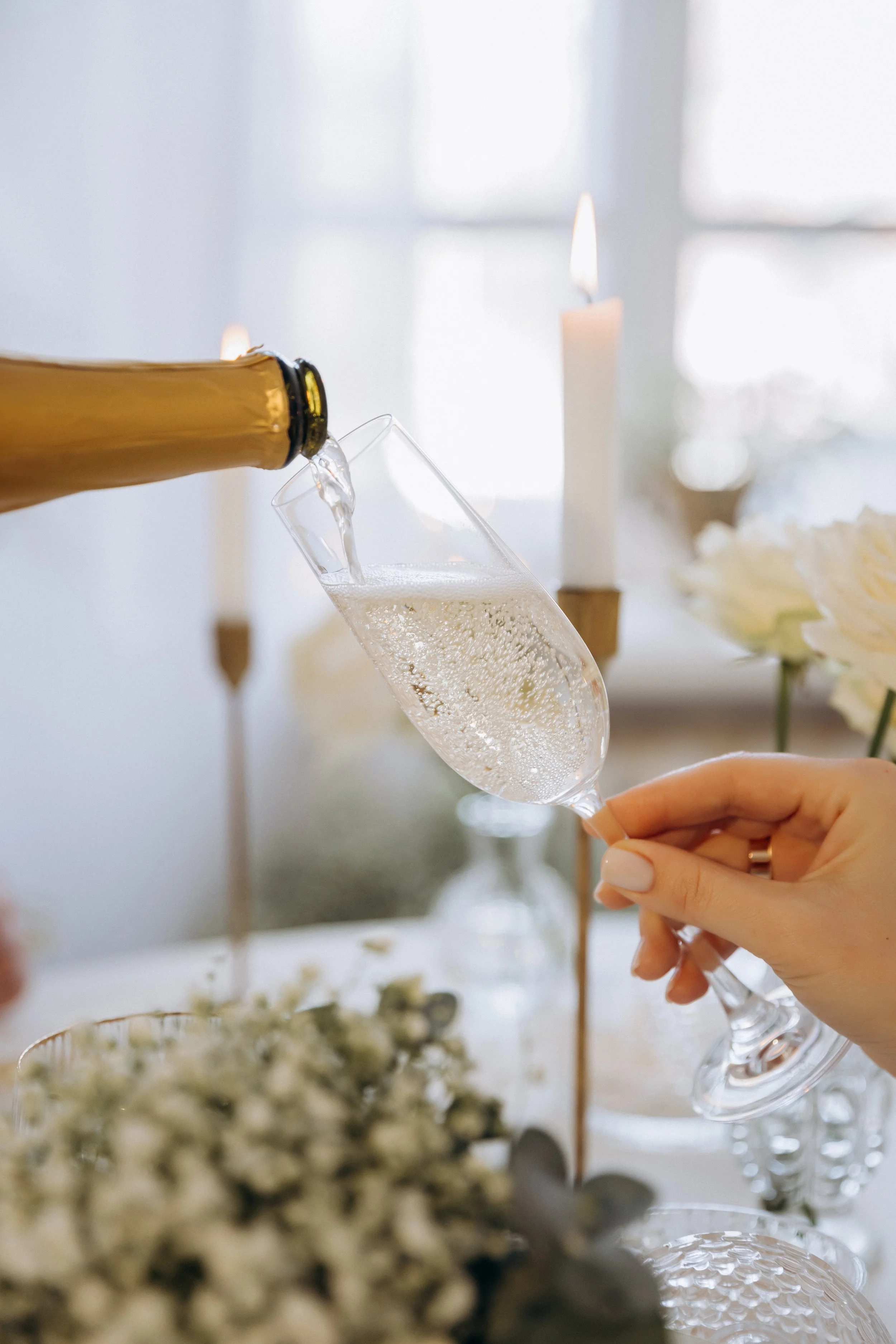 waitress-pouring-champagne-from-bottle-into-glass-restaurant-celebration-event.jpg
