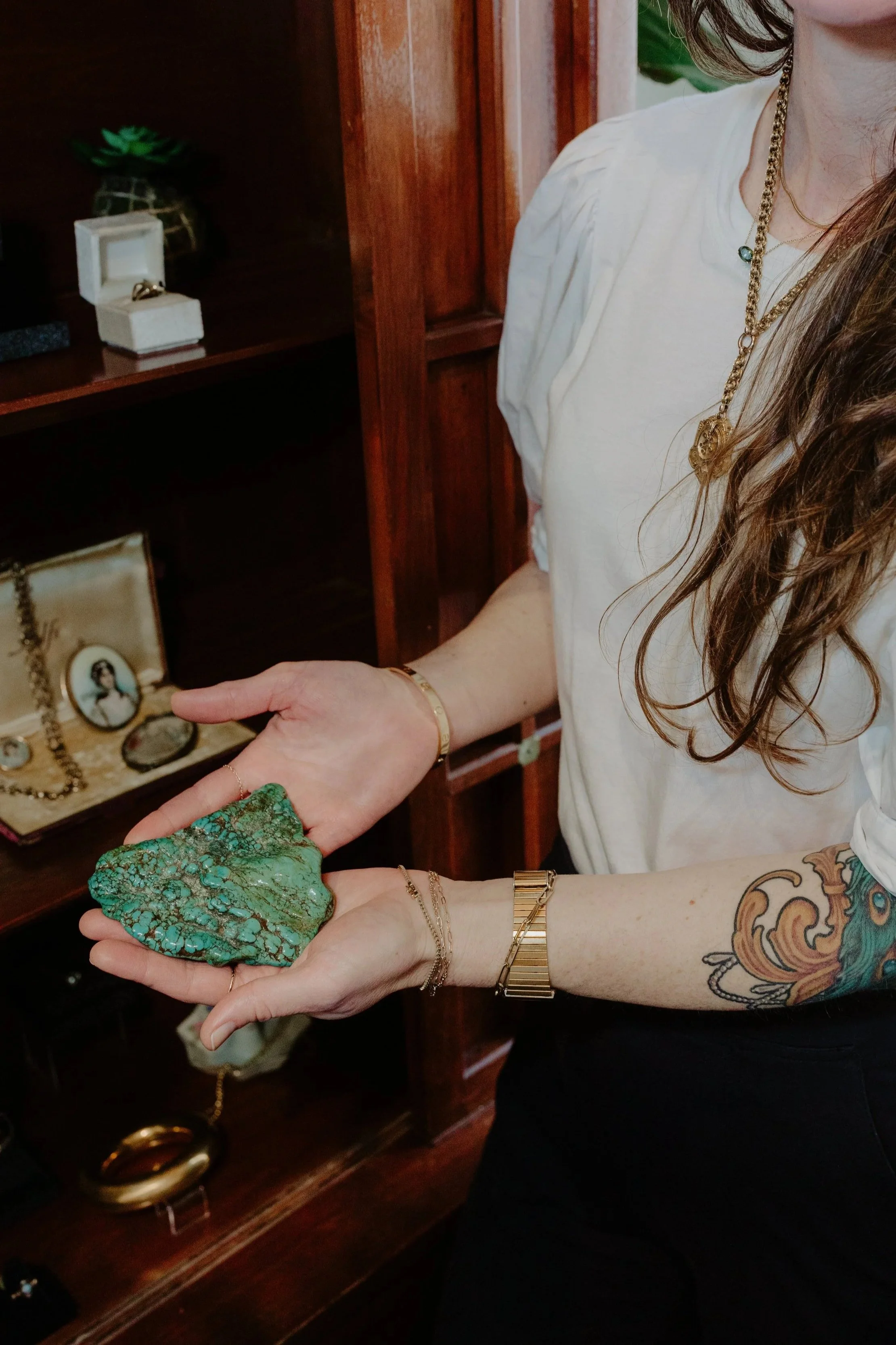 Designer April Cromer displays a large slab of Kingman Mine turquoise in the Lady Cromer Jewelry showroom. 