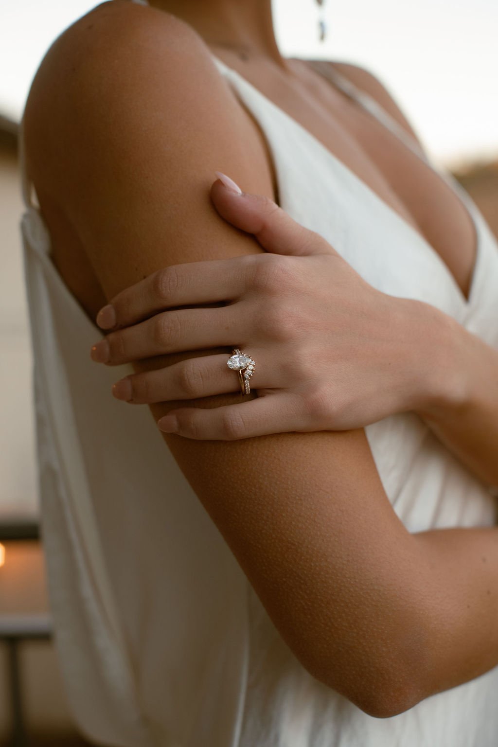 A close up of a bride's wedding ring set in 14k gold with diamonds in a unique setting, designed and made by Lady Cromer Jewelry. 