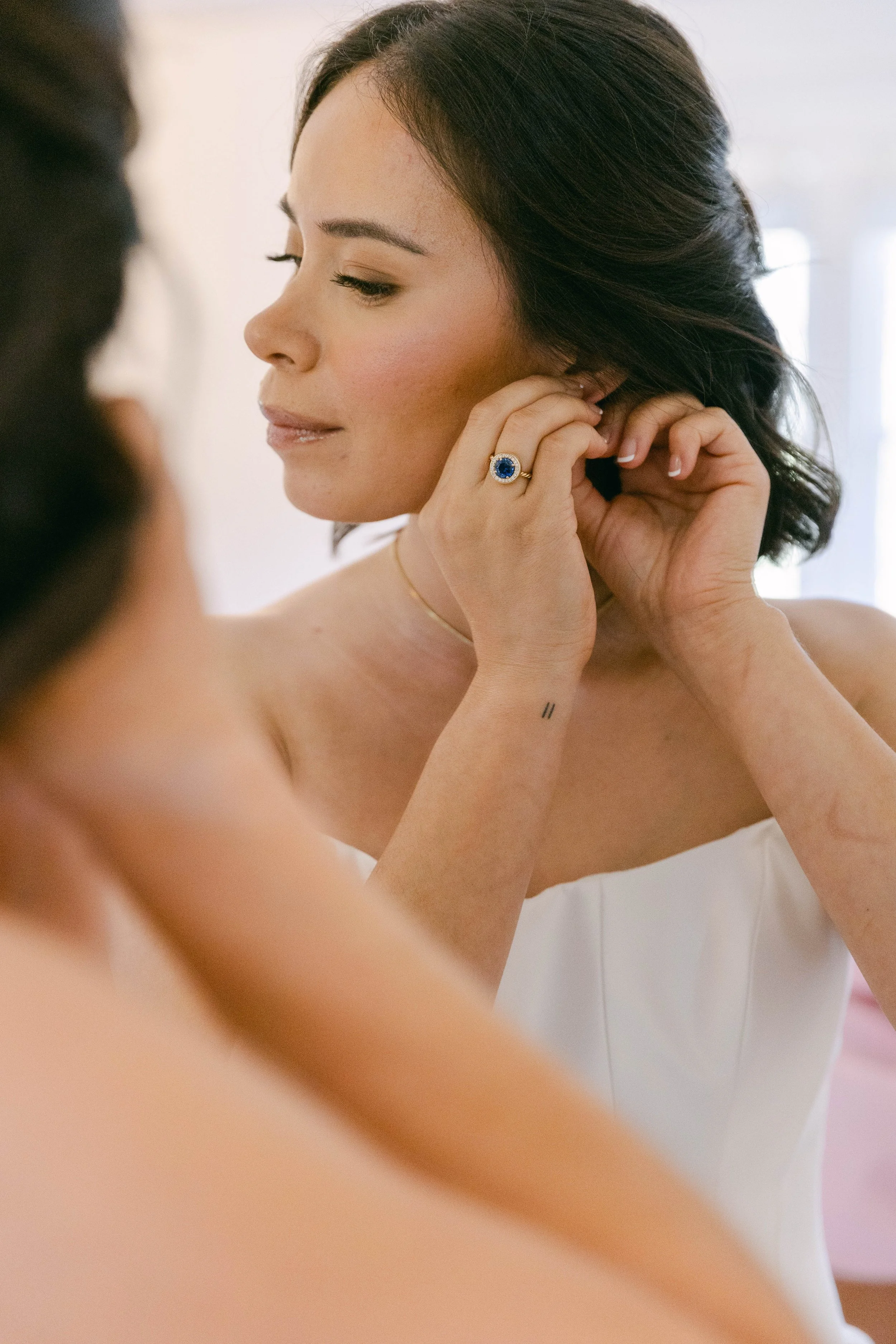 Custom made alternative engagement ring featuring a sapphire surrounded by a halo of diamonds. Photo by Adriana Michele Photography
