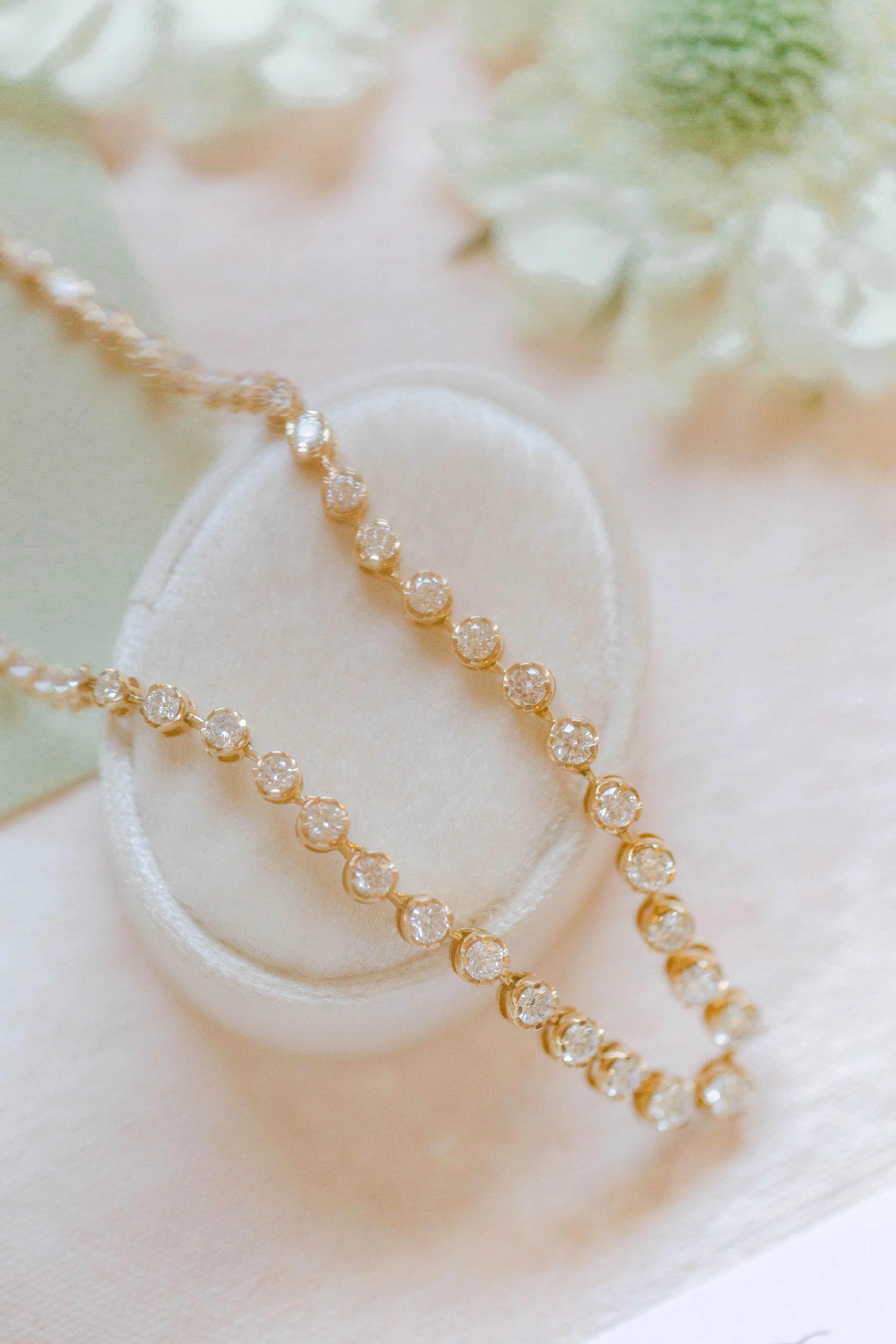 A 14k gold and graduated diamond tennis necklace by Lady Cromer Jewelry. 