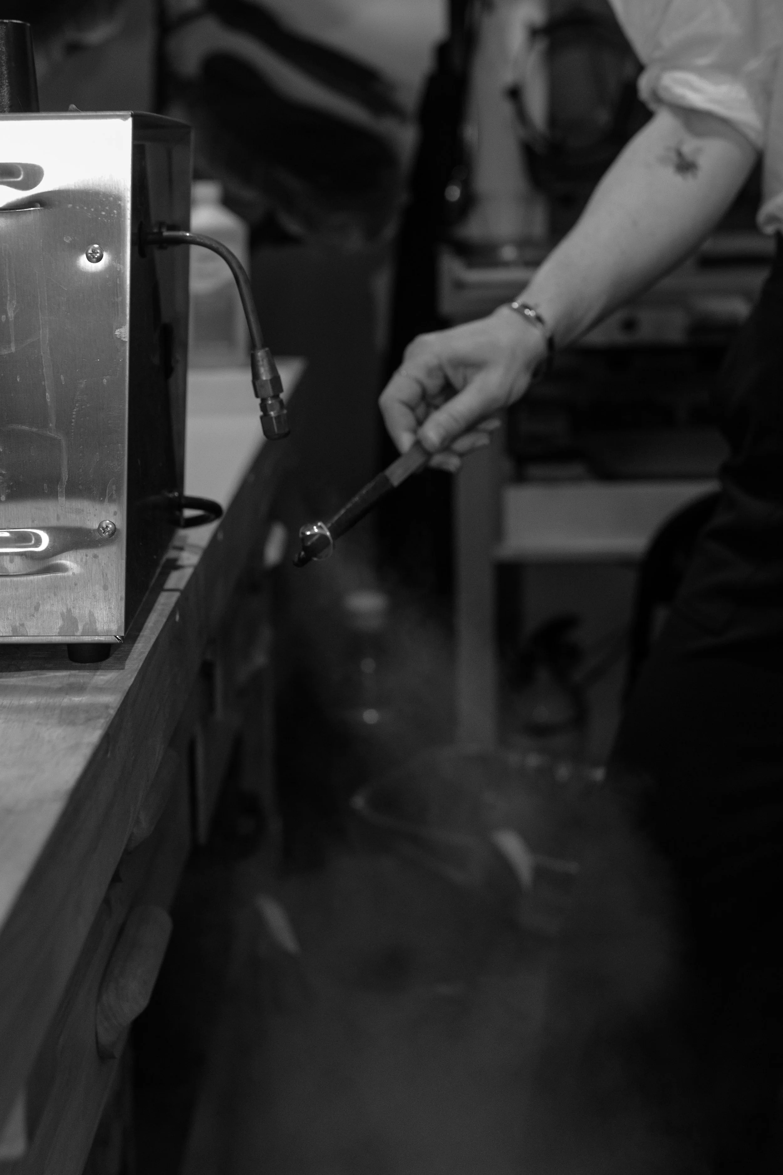 Custom jewelry designer April Cromer steam cleaning a ring in the Lady Cromer Jewelry showroom in San Diego
