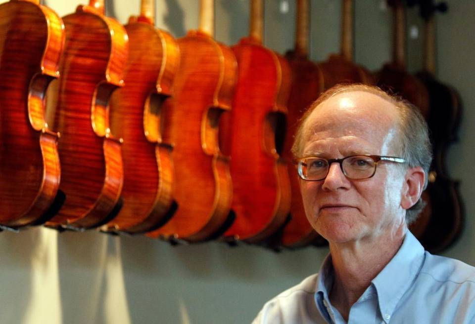 John Montgomery stands next to violins at his shop, John Montgomery Violins in Raleigh, NC on Monday, June 15, 2015. John Montgomery helped stop men who were trying to sell him stolen violins from Atlanta, Georgia. 