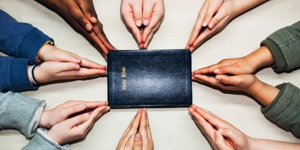 kids-hands-around-bible-590x295.jpg