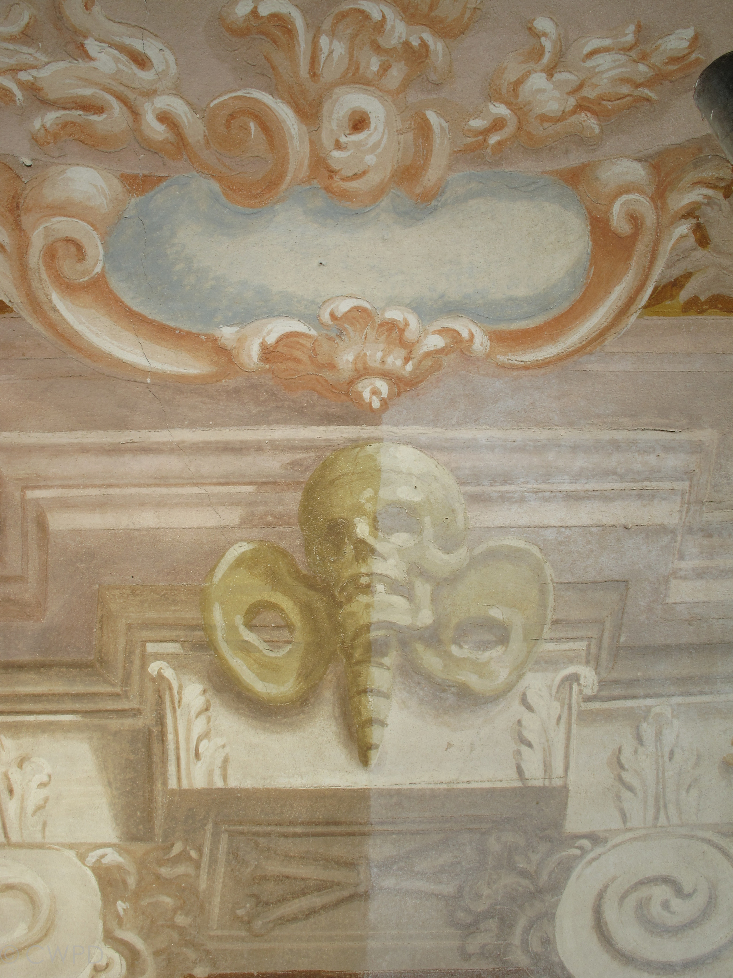  The wall paintings during cleaning. A layer of salt efflorescence, loose dirt, and microbiological growth has been cleaned from the left side of the image but remains on the right.&nbsp;  Image © Courtauld CWPD 