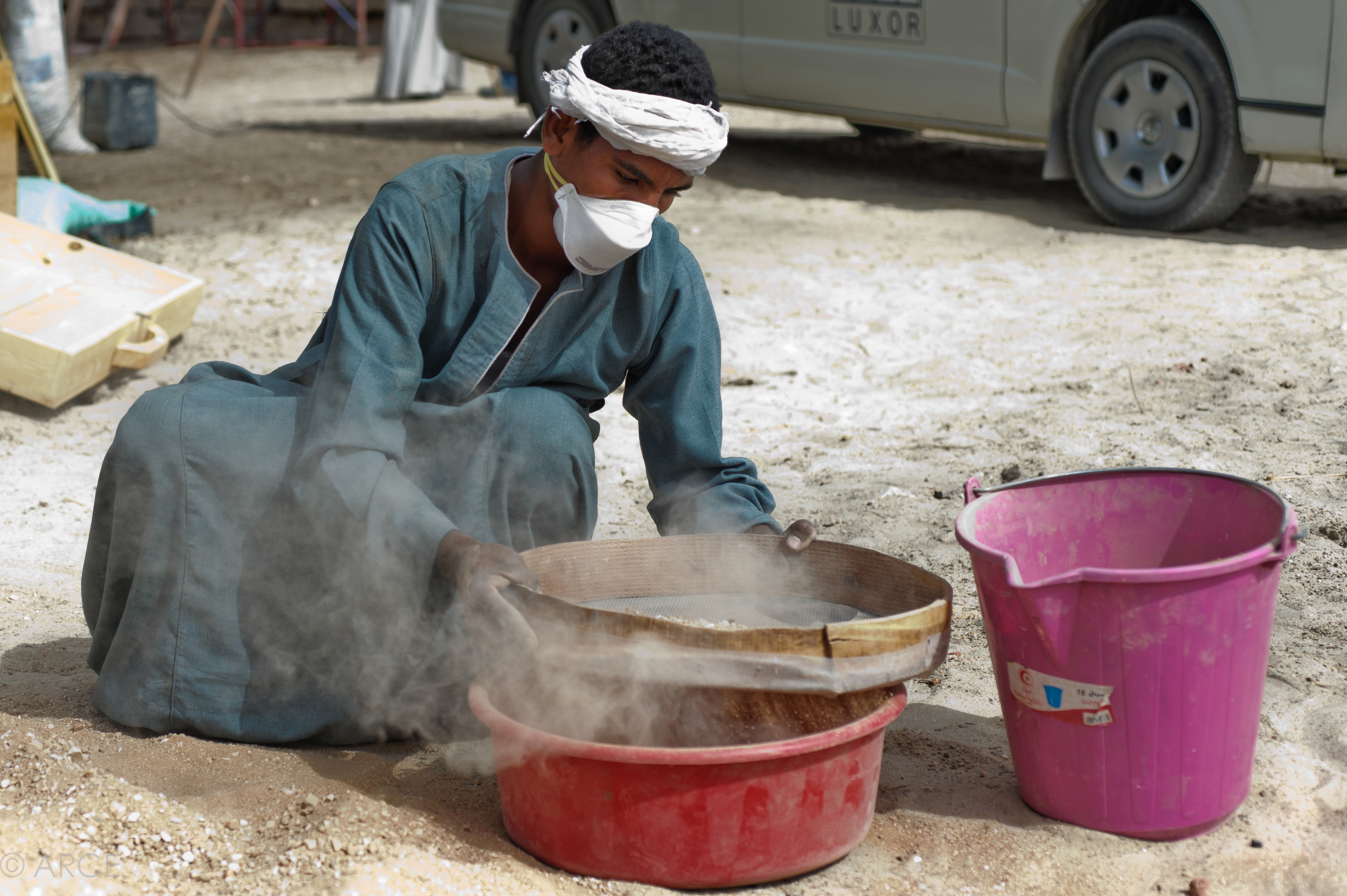  Preparation of lime mortar for repointing of the temple’s fabric. Brick dust and local sand were sieved and washed to provide filler for the mortar.  Image © ARCE, 2012 