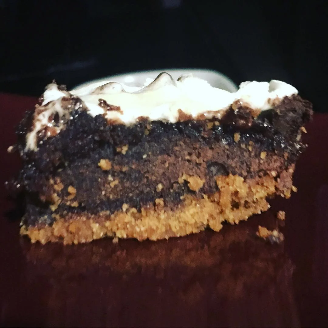 Layers of graham crackers, brownies, marshmallows, and chocolate.