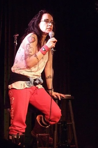 Janeane Garofalo on stage with tattoos