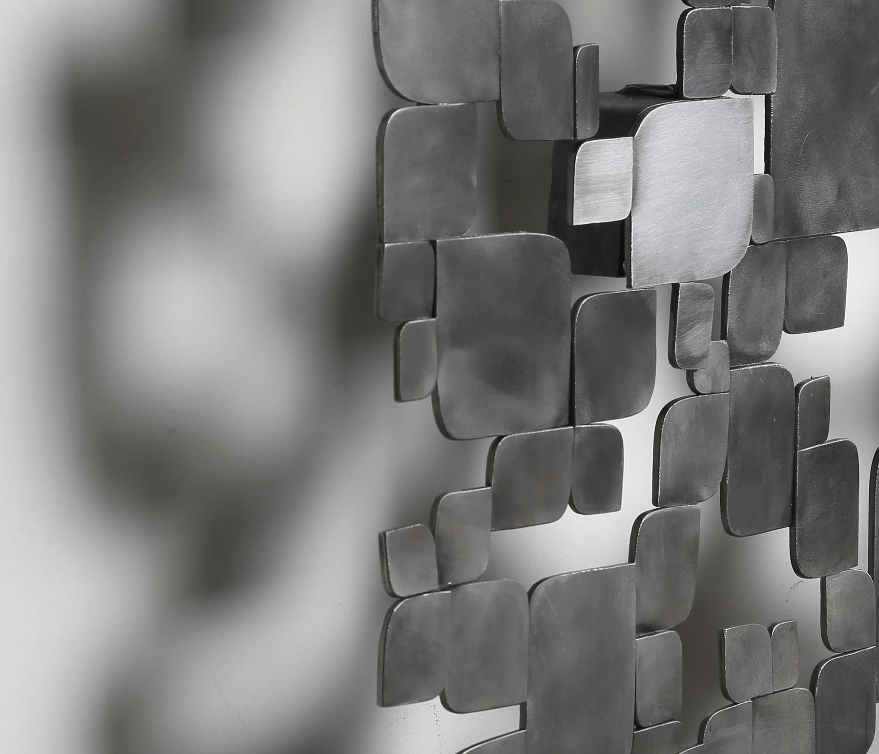 This piece is made of hundreds of hand cut and shaped steel pieces welded into a topographical sheet.