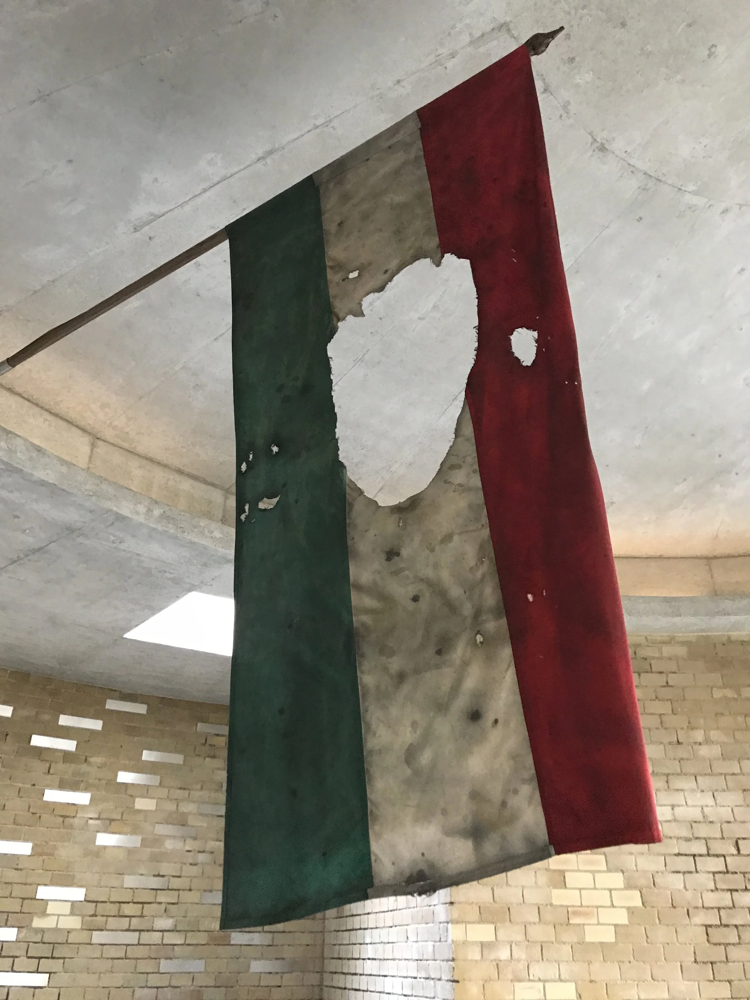  The flag of the 1956 revolution.  We took this just outside Parliament in the underground 1956 memorial. On October 23, 1956, Hungary made a bold statement against Soviet occupation and the terror it inflicted on government members and low-class fam