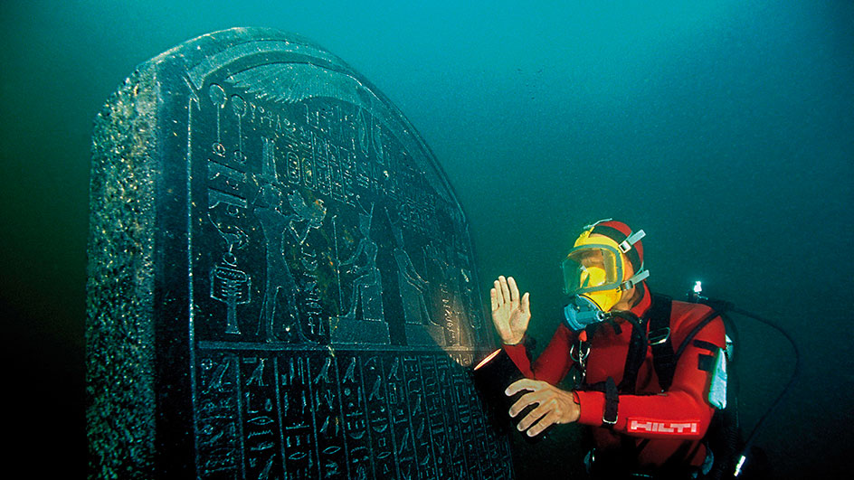 A diver shows a marble statue of Osiris