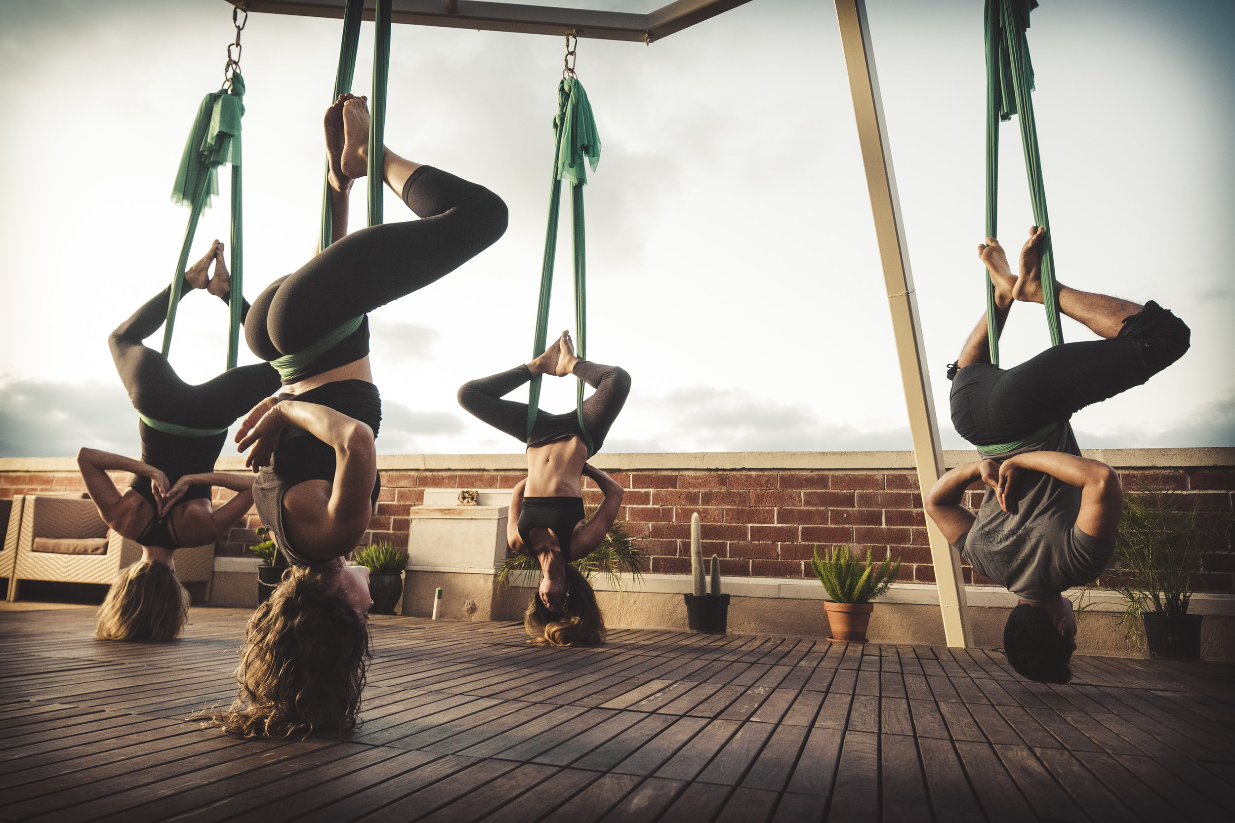 7 Aerial Yoga Benefits For Soaring Fitness, According To A Trainer
