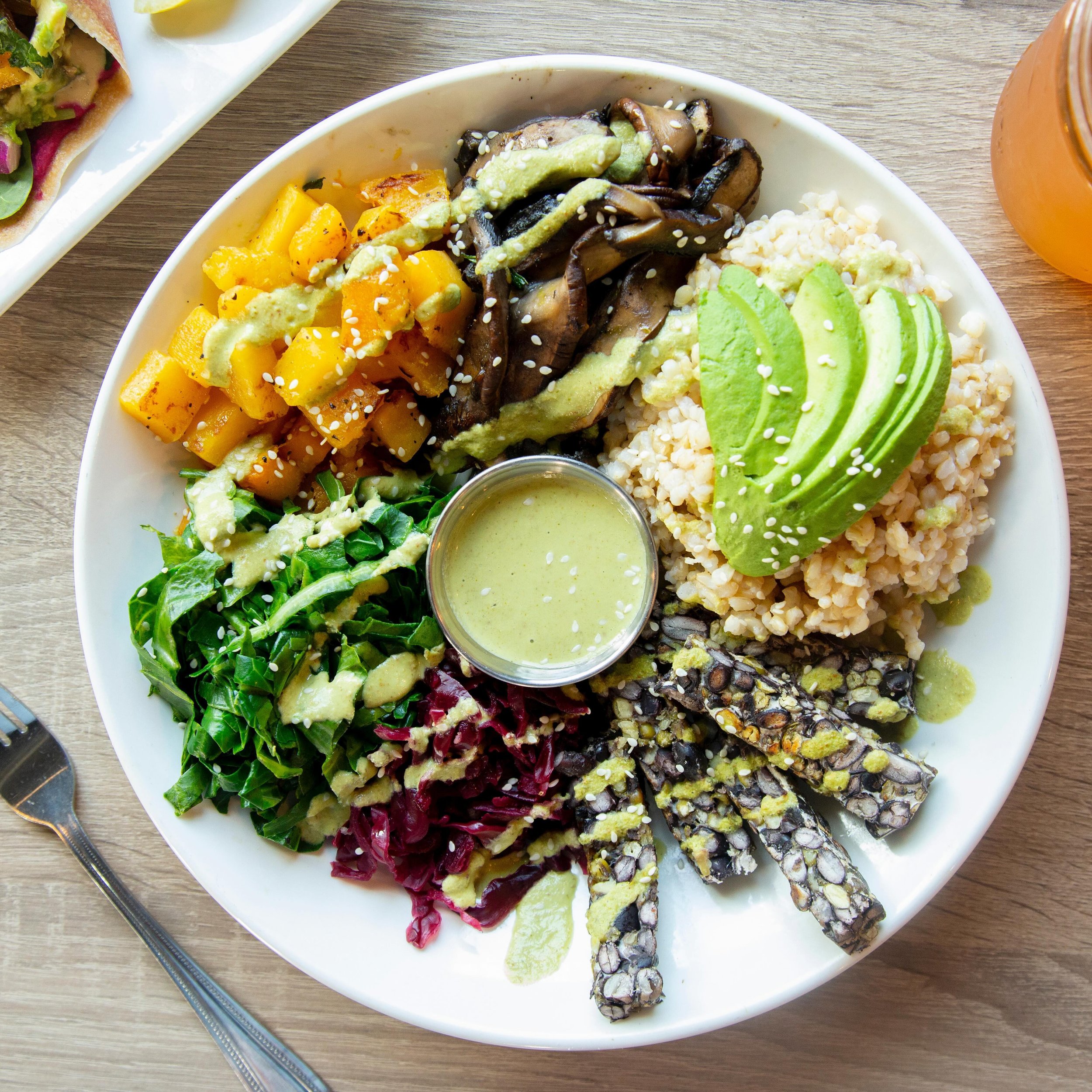 Discover the power of plant-based eating at our Cafe 🌱 Our Plant Powered protein bowl is packed with goodness: brown rice for sustained energy, protein-rich mung &amp; black bean tempeh for muscle fuel, and nutrient-dense ingredients like portobello