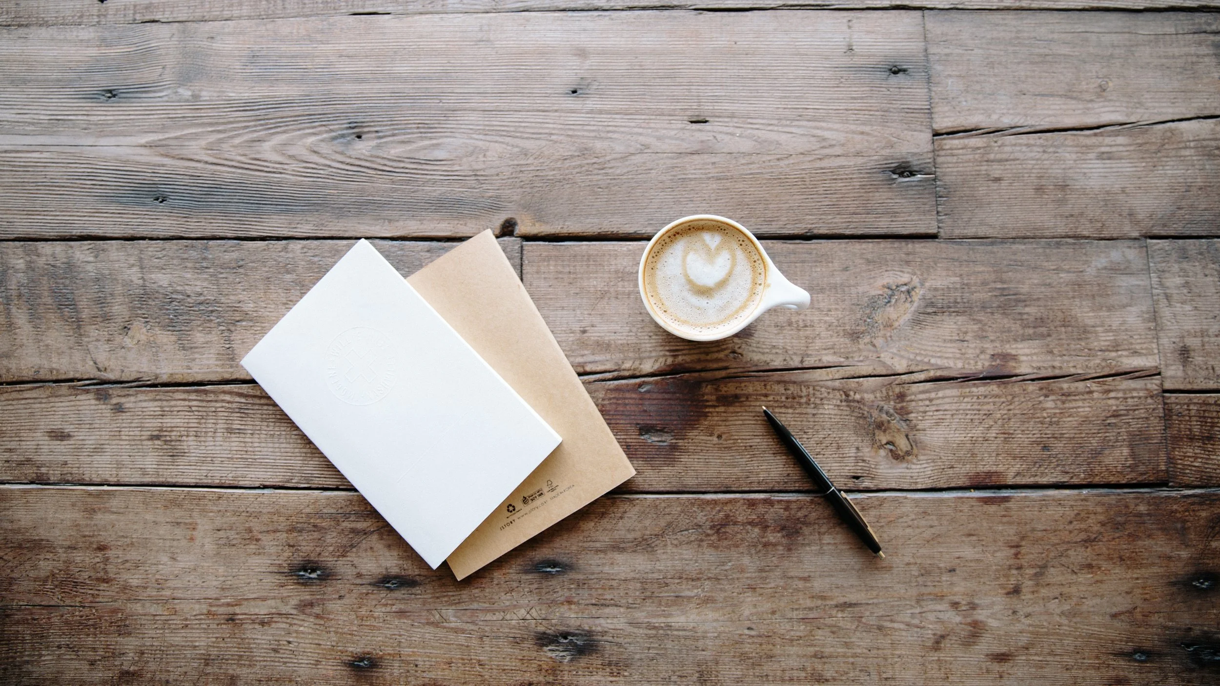 Coffee and Notebook on a Wooden Table Church Stock Photo.jpg