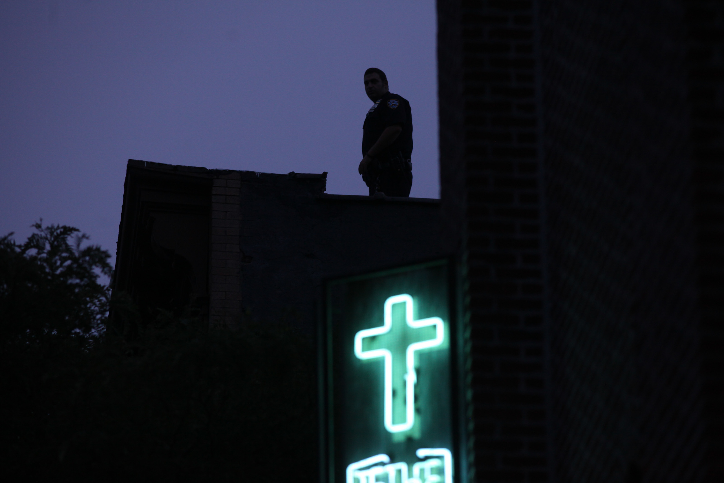  NYPD officer on a rooftop during the funeral for Eric Garner, who died after being placed in a chokehold by NYPD for selling loose cigarettes in Staten Island.&nbsp; 