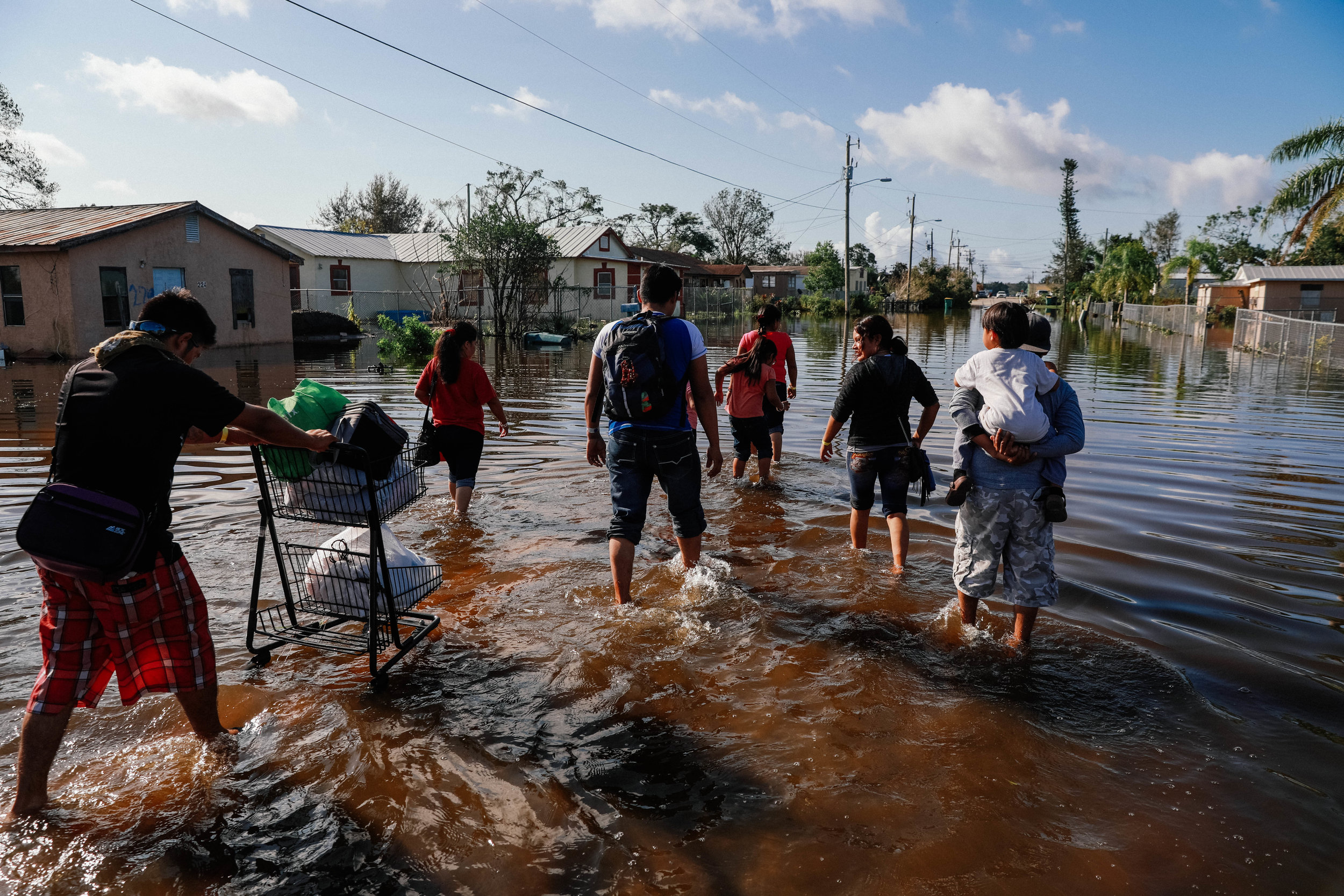  Residents of Immokolee, FL trudge through a flooded street after Hurricane Irma 