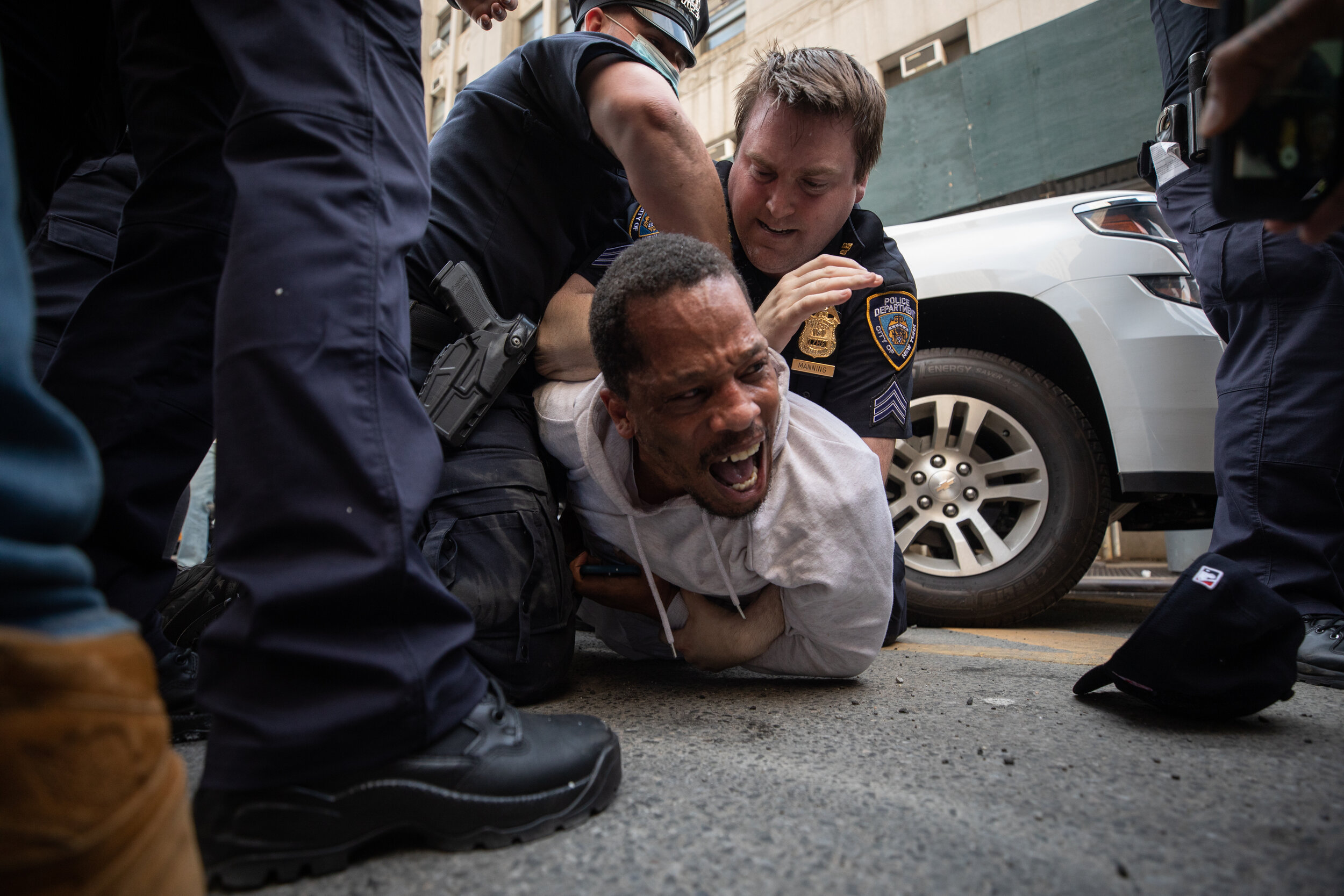  May 29, 2020: New York, NY -   A man is detained as protesters clash with NYPD officers near Foley Square after George Floyd was killed while being detained by Minneapolis police on May 25.  