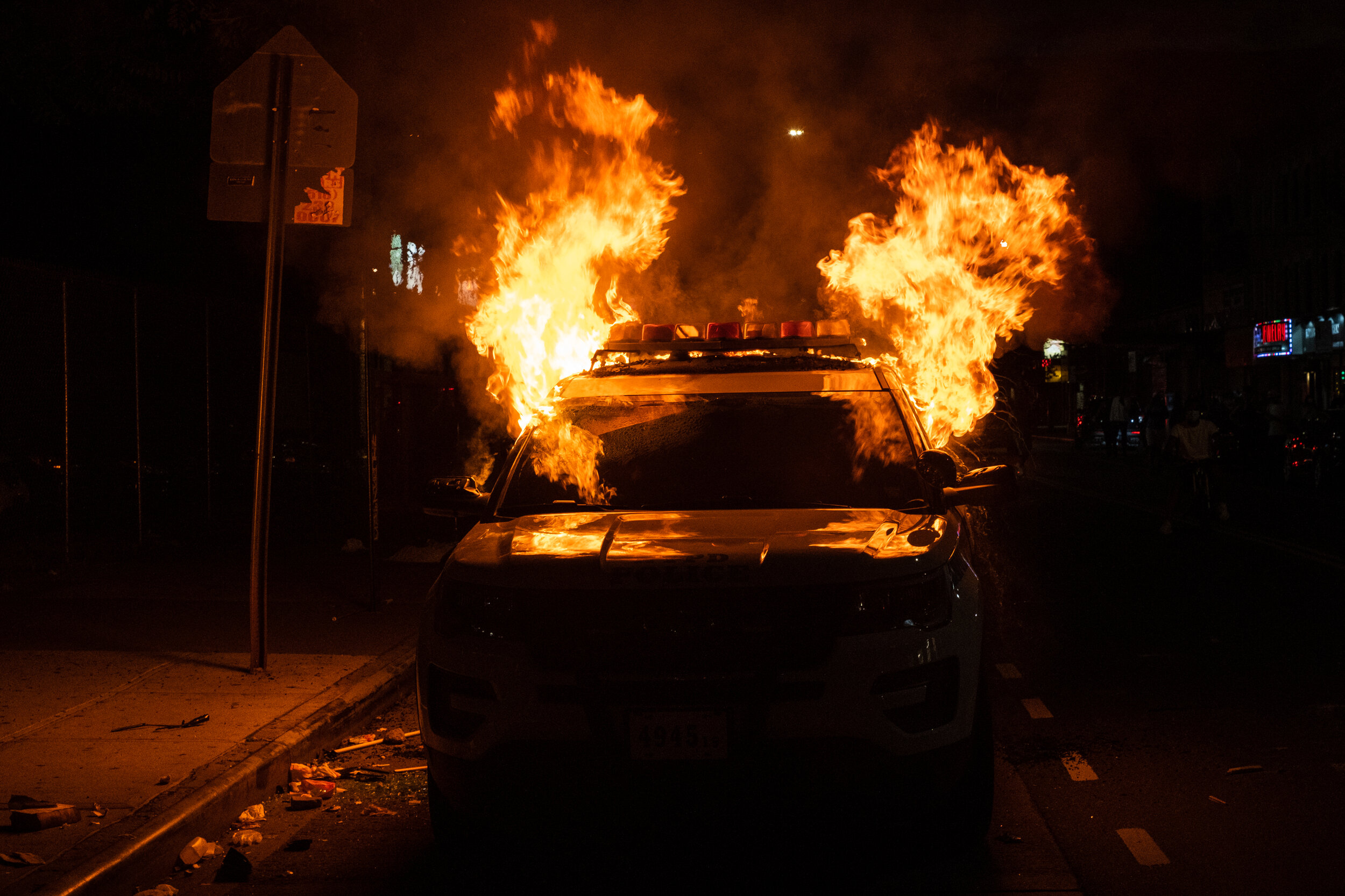  May 30, 2020: New York, NY -   A NYPD vehicle is set on fire as protesters clash with NYPD officers in Flatbush, Brooklyn after George Floyd was killed while being detained by Minneapolis police on May 25.  