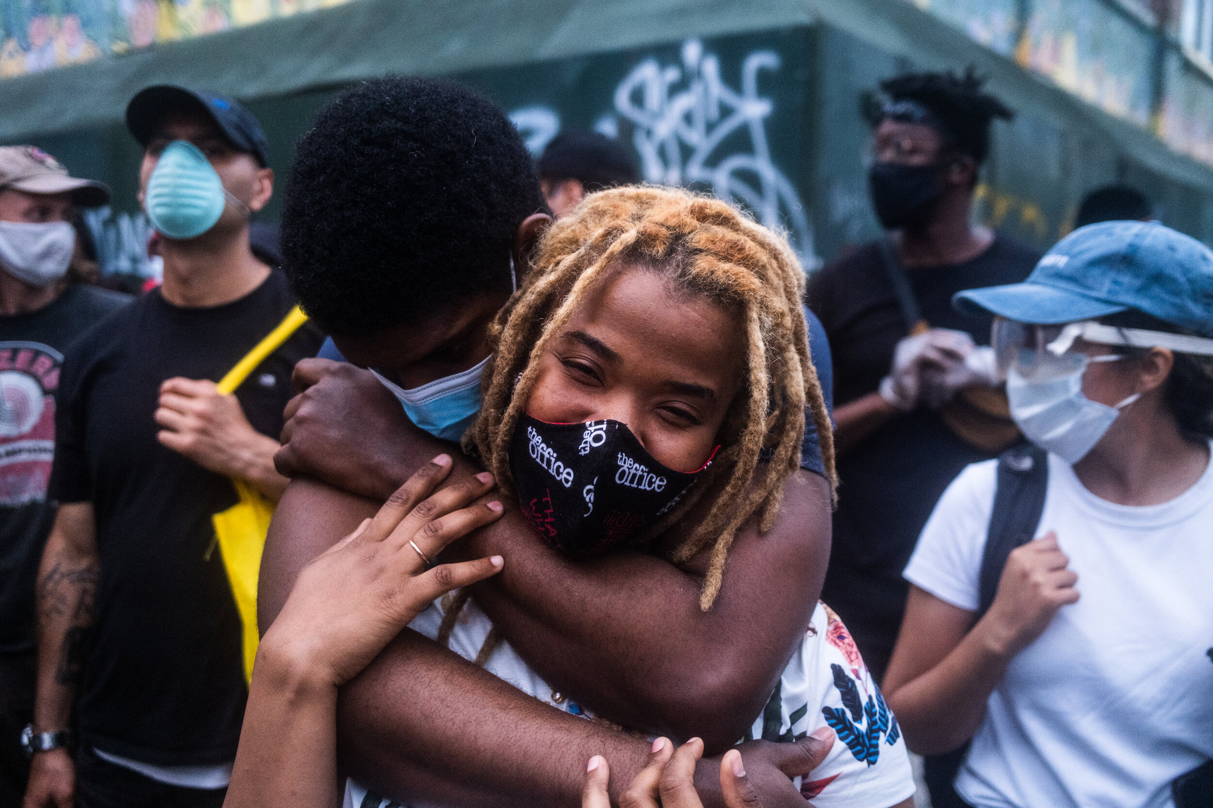  May 30, 2020: New York, NY -   A man and a woman embrace as protesters clash with NYPD officers in Flatbush, Brooklyn after George Floyd was killed while being detained by Minneapolis police on May 25.  