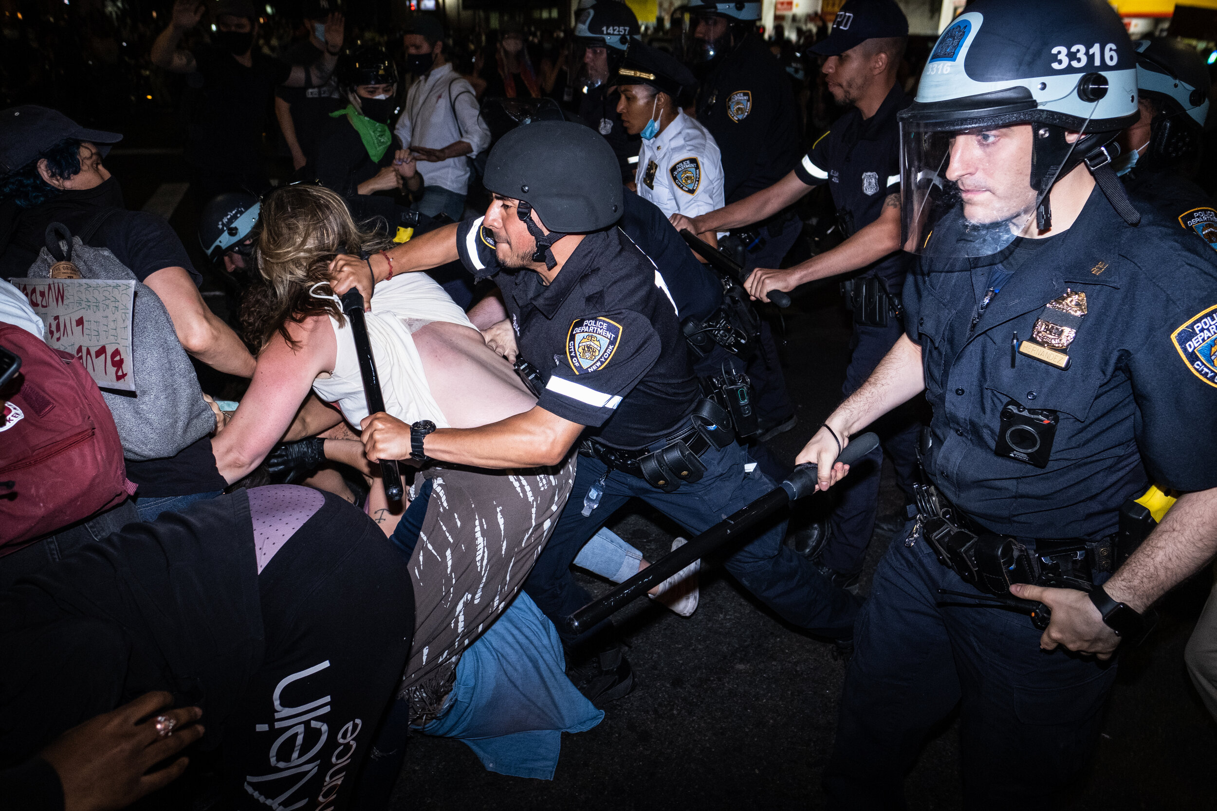  May 30, 2020: New York, NY -   Police use batons in an attempt to clear a street as protesters clash with NYPD officers in Flatbush, Brooklyn after George Floyd was killed while being detained by Minneapolis police on May 25.  