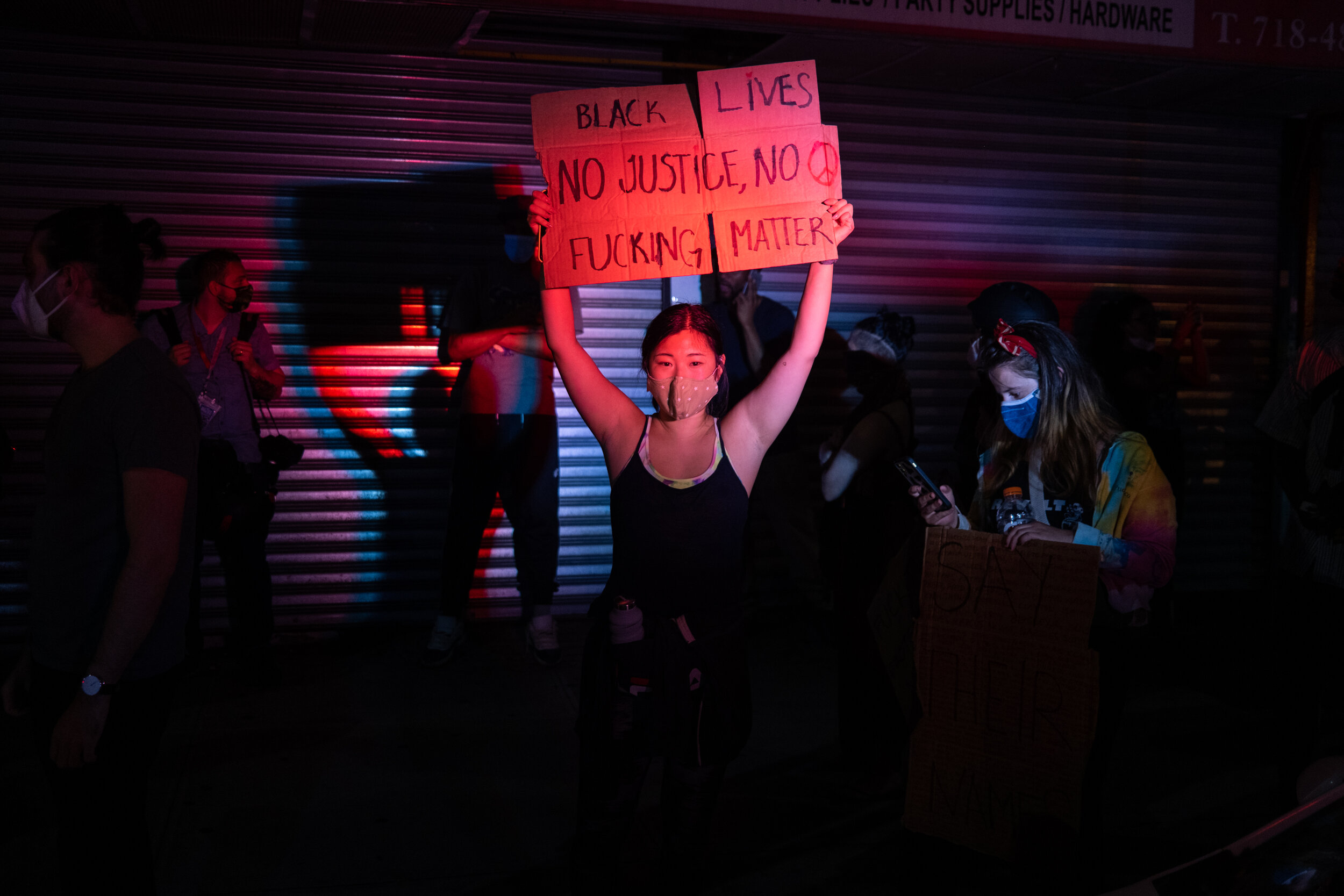  May 29, 2020: New York, NY -   A holds a sign as protesters clash with NYPD officers near Foley Square after George Floyd was killed while being detained by Minneapolis police on May 25.  