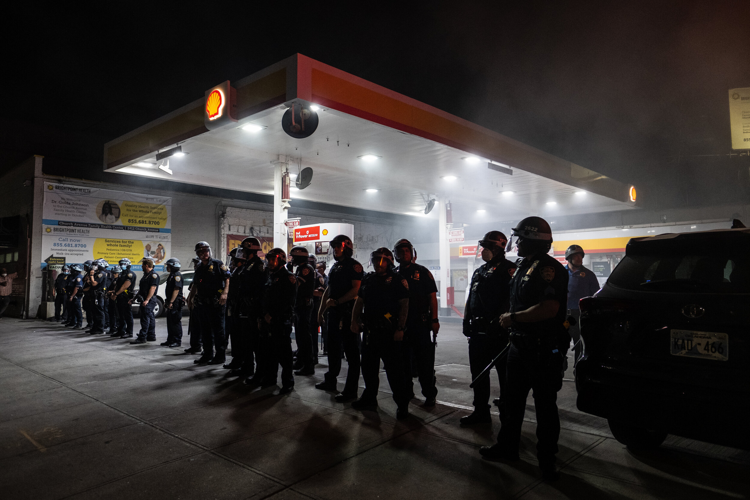  May 30, 2020: New York, NY -   Police block a gas station as protesters clash with NYPD officers in Flatbush, Brooklyn after George Floyd was killed while being detained by Minneapolis police on May 25.  