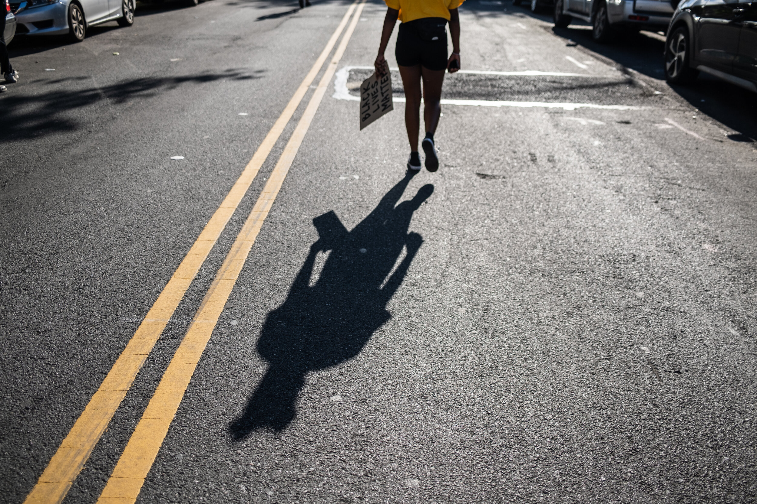  May 31, 2020: New York, NY -  A woman holds a sign in Flatbush, Brooklyn after George Floyd was killed while being detained by Minneapolis police on May 25.  