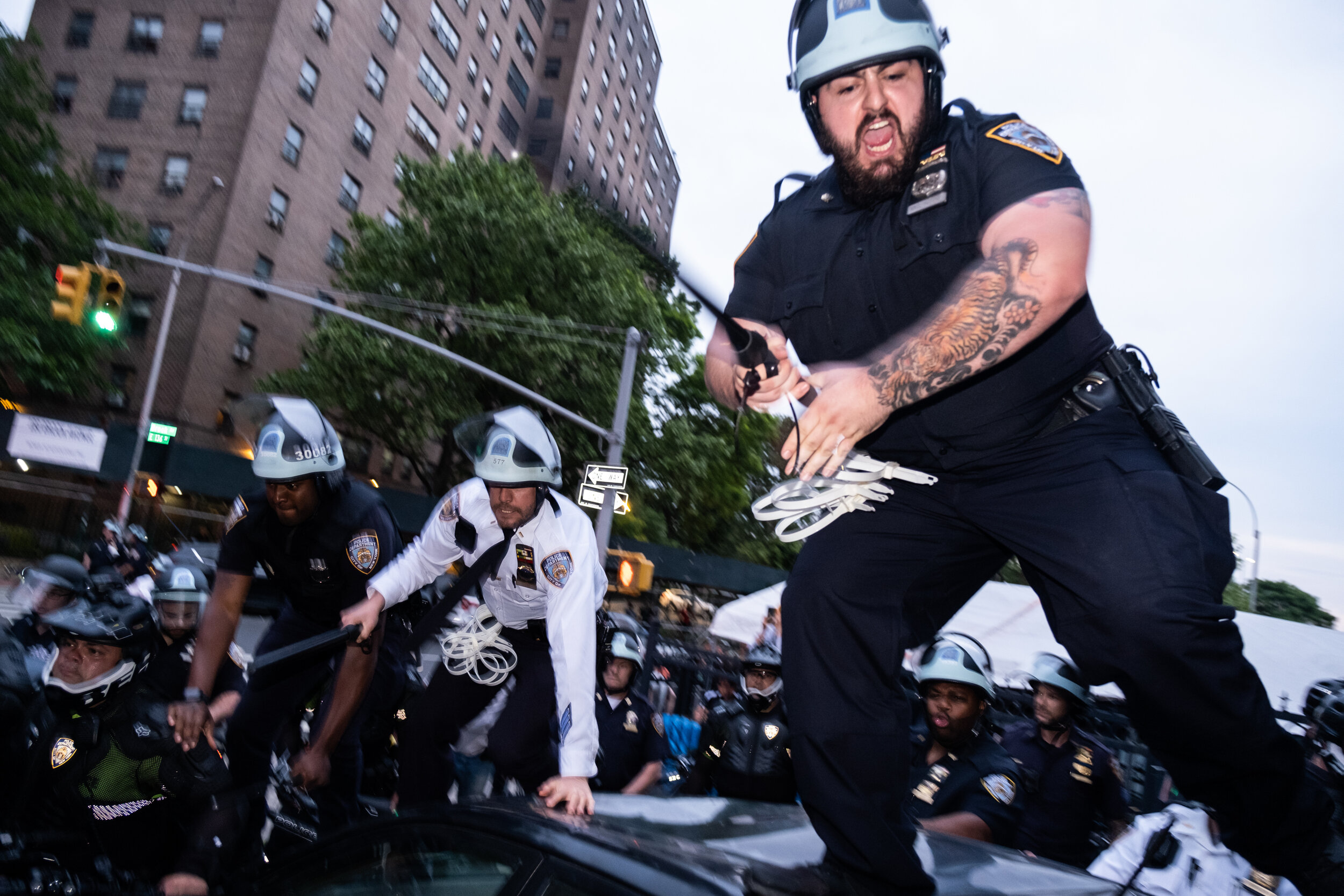  June 4, 2020: New York, NY -   Police officers surround a group of people in the South Bronx as protesters and NYPD clash after George Floyd was killed while being detained by Minneapolis police on May 25.  